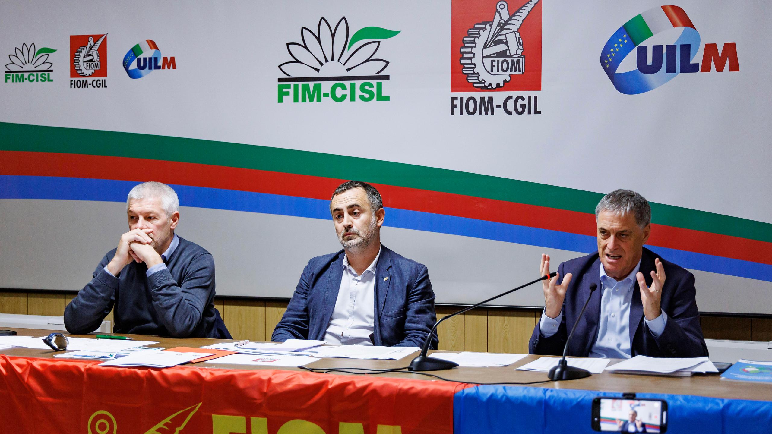 Fernando Uliano of Fim Cisl union, left, Michele De Palma of Fiom Cgil union, centre, and Rocco Palombella of Uilm union hold a news conference to announce the mobilization of Stellantis workers and the entire automotive supply chain, in Rome, Tuesday, Sept. 24, 2024. (Roberto Monaldo/LaPresse via AP)