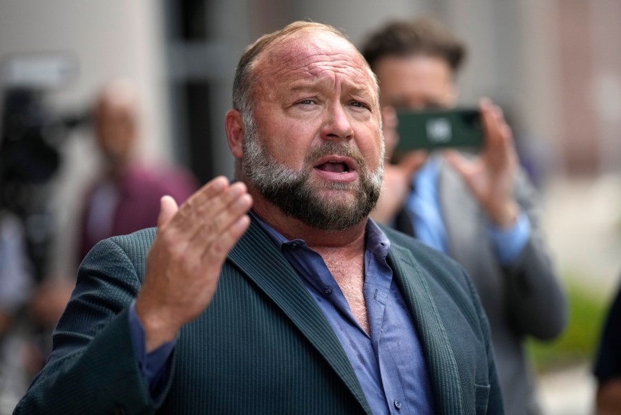 FILE - Alex Jones speaks to the media after arriving at the federal courthouse for a hearing in front of a bankruptcy judge, June 14, 2024, in Houston. (AP Photo/David J. Phillip, File)