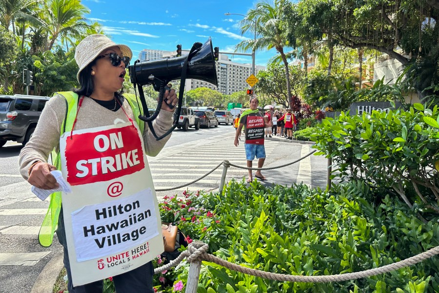 Estella Fontanilla, a housekeeper on strike from the Hilton Hawaiian Village, leads fellow hotel workers in strike chants on Tuesday, Sept. 24, 2024, in Honolulu. (AP Photo/Jennifer Sinco Kelleher)