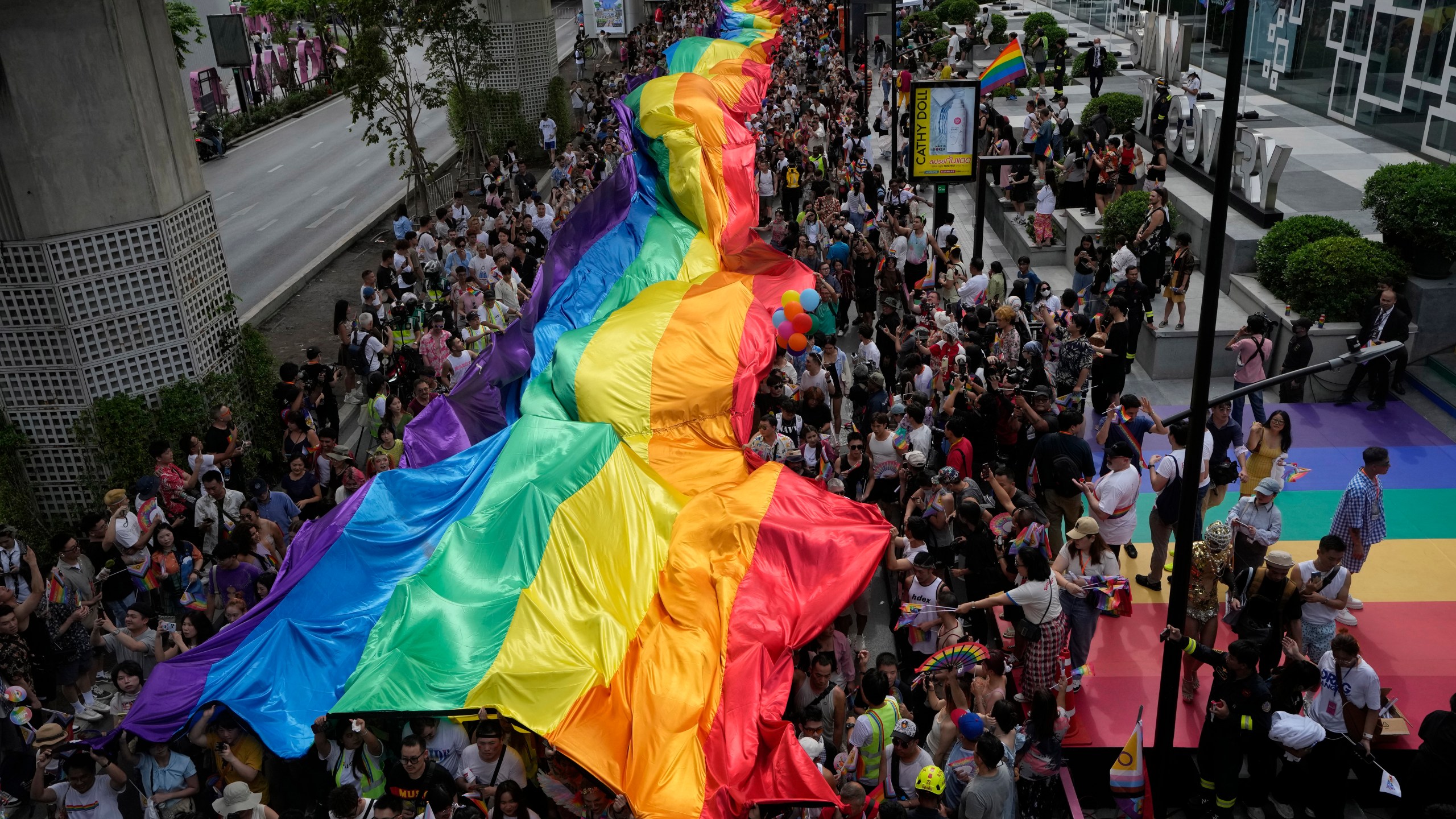 FILE - Participants hold a rainbow flag during the Pride Parade in Bangkok, Thailand, Saturday, June 1, 2024. (AP Photo/Sakchai Lalit, File)