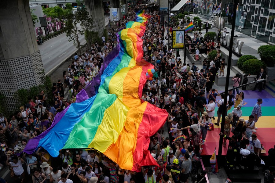 FILE - Participants hold a rainbow flag during the Pride Parade in Bangkok, Thailand, Saturday, June 1, 2024. (AP Photo/Sakchai Lalit, File)