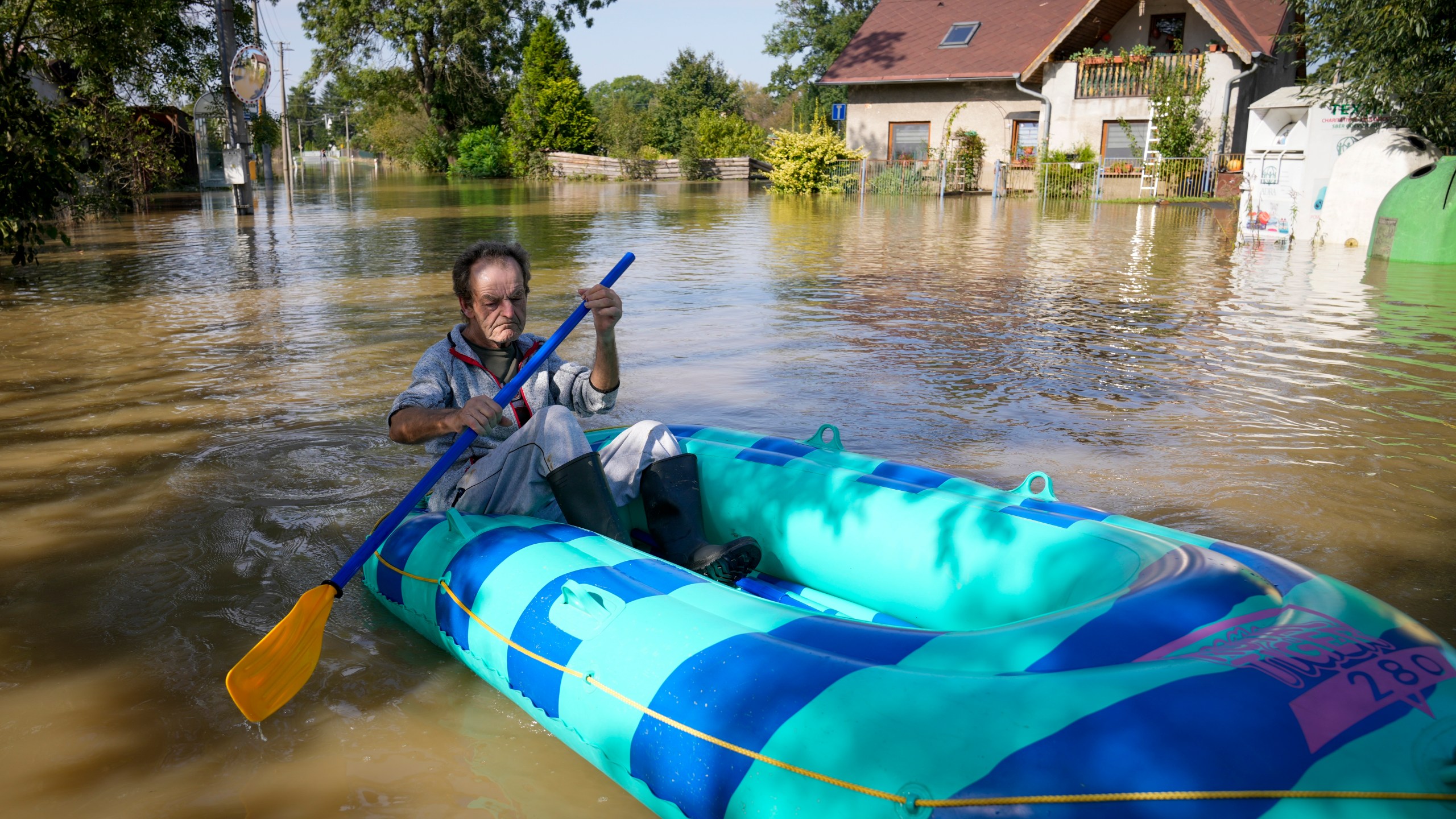 FILE - A resident paddles through a flooded street in Bohumin, Czech Republic, Sept. 17, 2024. (AP Photo/Darko Bandic, File)