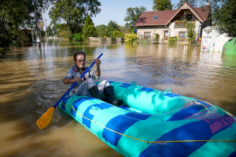 FILE - A resident paddles through a flooded street in Bohumin, Czech Republic, Sept. 17, 2024. (AP Photo/Darko Bandic, File)