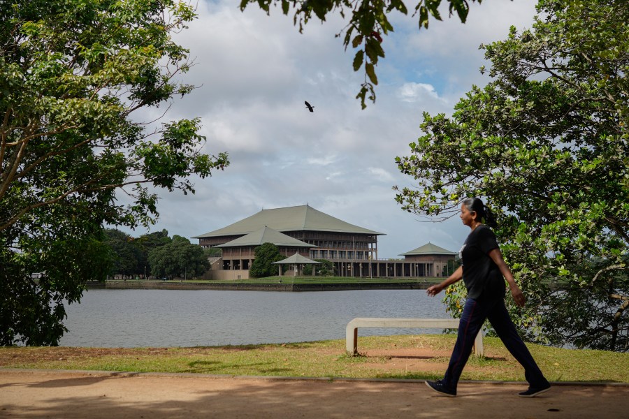 A woman walks outside the parliamentary complex in Colombo, Sri Lanka, Wednesday, Sept. 25, 2024. (AP Photo/Eranga Jayawardena)