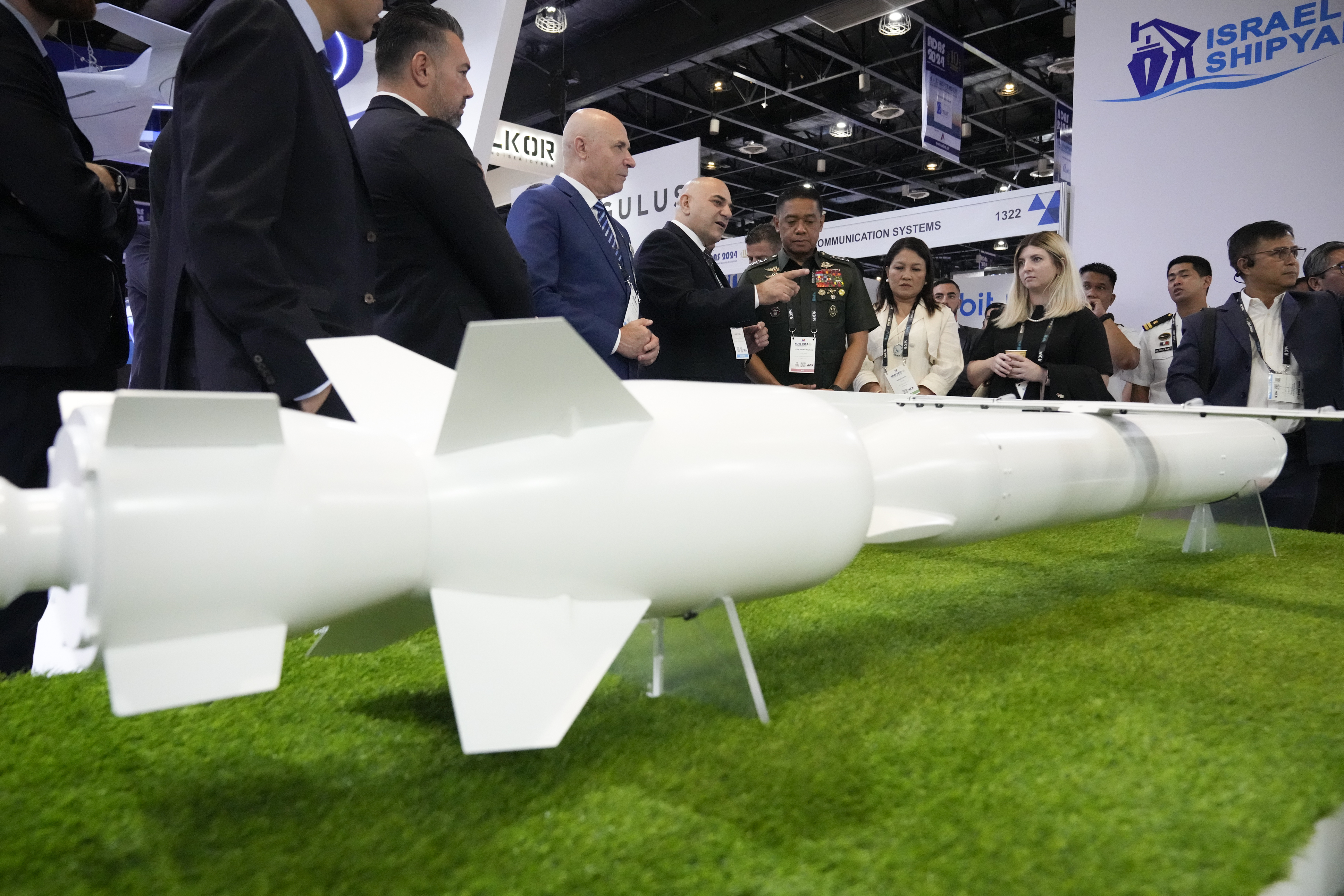 Philippine military chief Gen. Romeo Brawner Jr. center, listens as an exhibitor explains the Wind Demon, a long range air to surface cruise missile, during the Asian Defense and Security Exhibition on Wednesday, Sept. 25, 2024, in Manila, Philippines. (AP Photo/Aaron Favila)