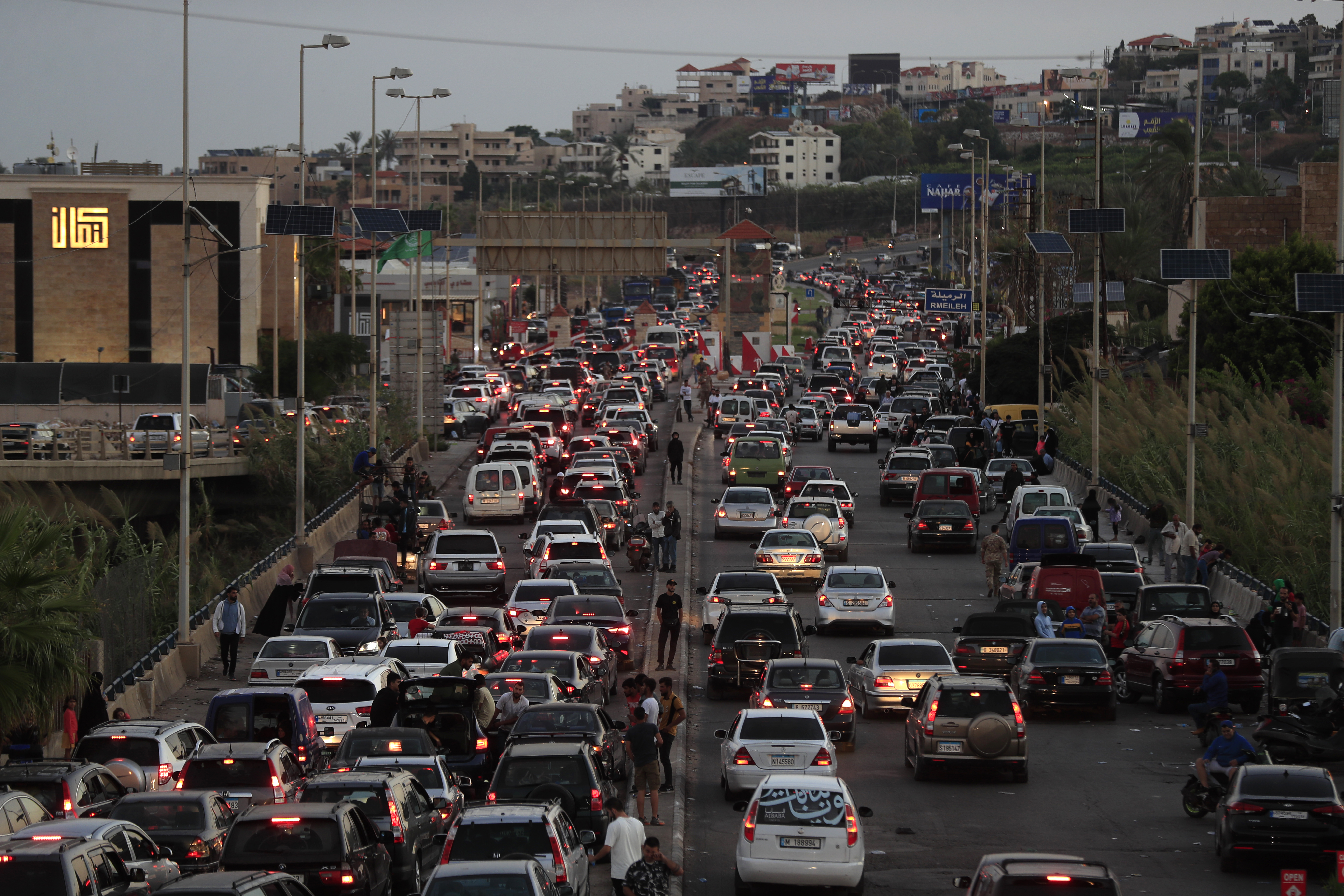 People who fled the southern villages amid ongoing Israeli airstrikes Monday, sit in their cars as they are stuck in traffic at a highway that links to Beirut city, in the southern port city of Sidon, Lebanon, Tuesday, Sept. 24, 2024. (AP Photo/Mohammed Zaatari)