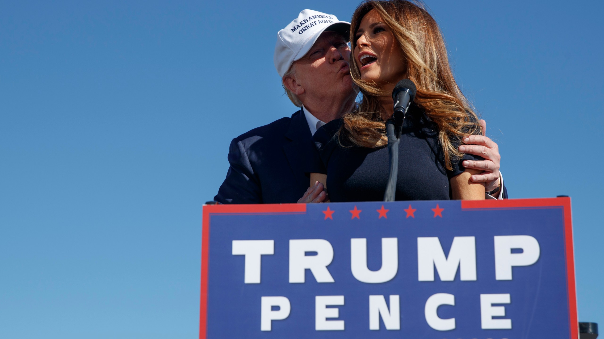 FILE - Republican presidential candidate Donald Trump, left, kisses his wife, Melania, during a campaign rally, Nov. 5, 2016, in Wilmington, N.C. (AP Photo/ Evan Vucci, File)