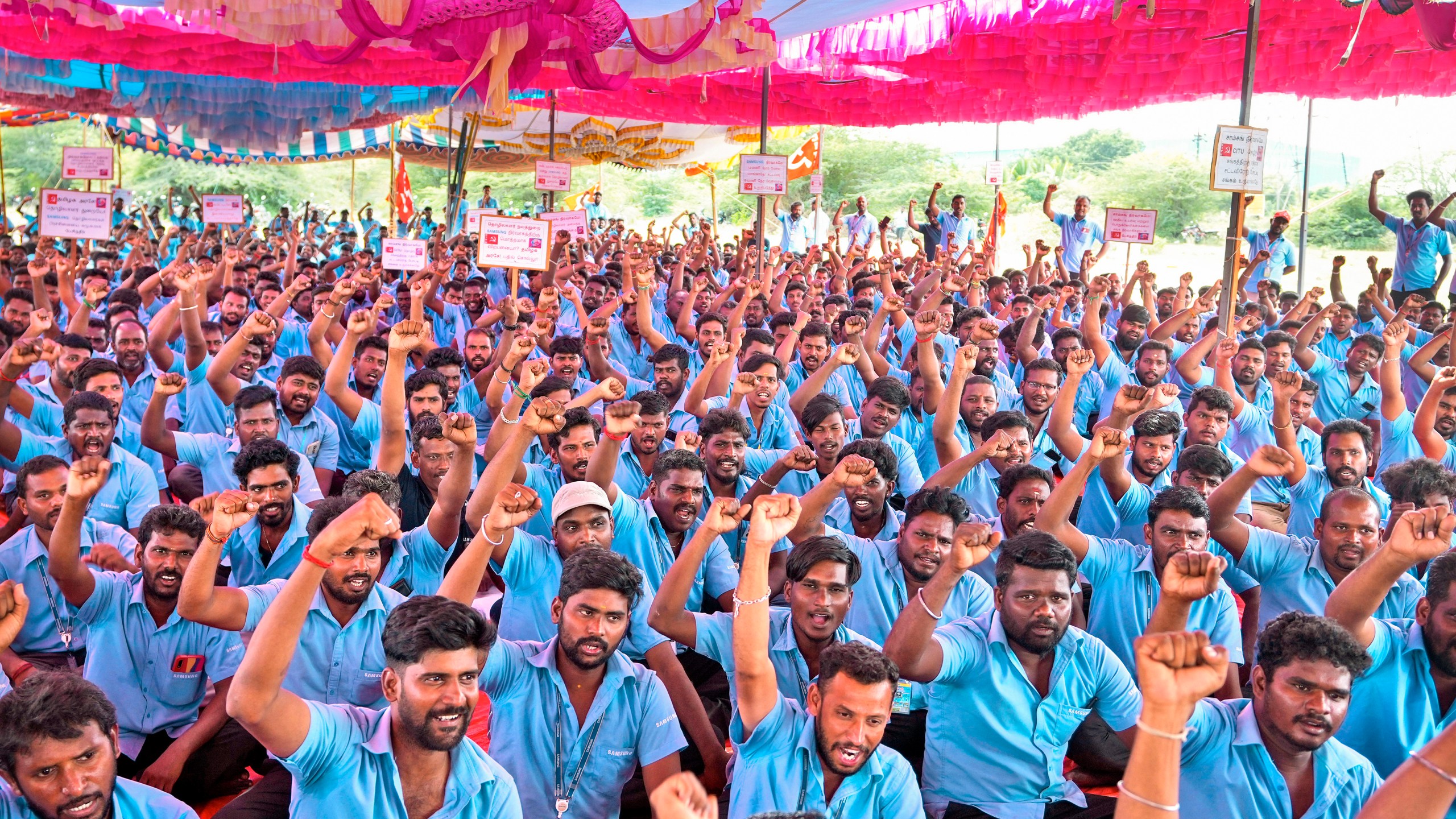 Samsung workers who are on strike shout slogans during a protest near their plant in Sriperumbudur, on the outskirts of Chennai, India, Tuesday, Sept. 24, 2024. (AP Photo/Mahesh Kumar A.)