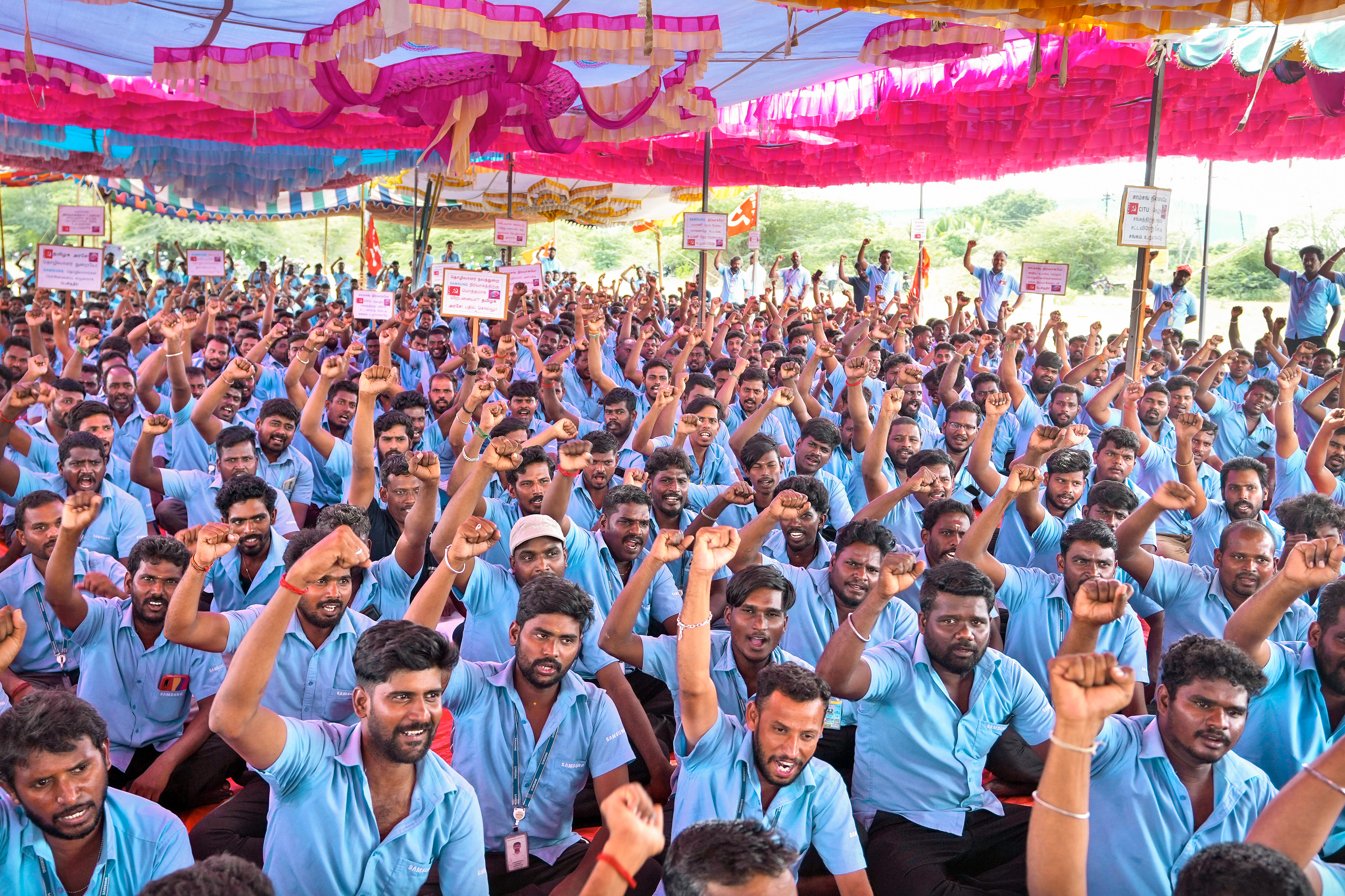 Samsung workers who are on strike shout slogans during a protest near their plant in Sriperumbudur, on the outskirts of Chennai, India, Tuesday, Sept. 24, 2024. (AP Photo/Mahesh Kumar A.)