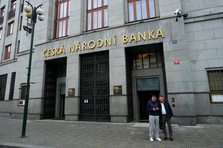 FILE - People stand outside the Czech central bank in Prague, Czech Republic, Thursday, Nov. 2, 2023. (AP Photo/Petr David Josek, File)