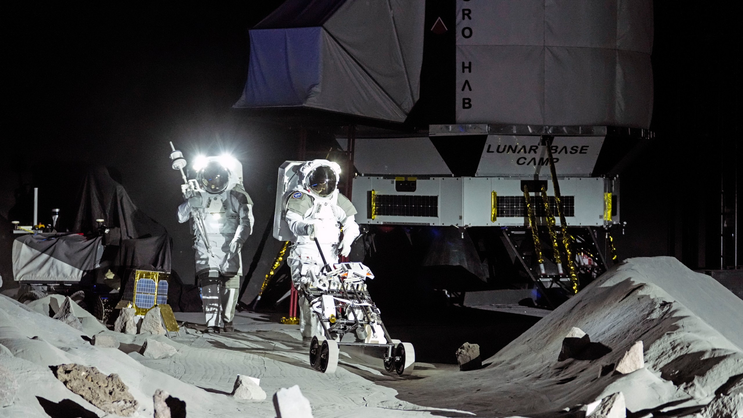 Astronauts Thomas Pesquet of France and Matthias Maurer of Germany demonstrate their training in lunar surface simulating conditions for future moon missions, like the Artemis lunar exploration program led by NASA, at the opening of the new LUNA facility at the European Astronaut Center in Cologne, Germany, Wednesday, Sept. 25, 2024. (AP Photo/Martin Meissner)