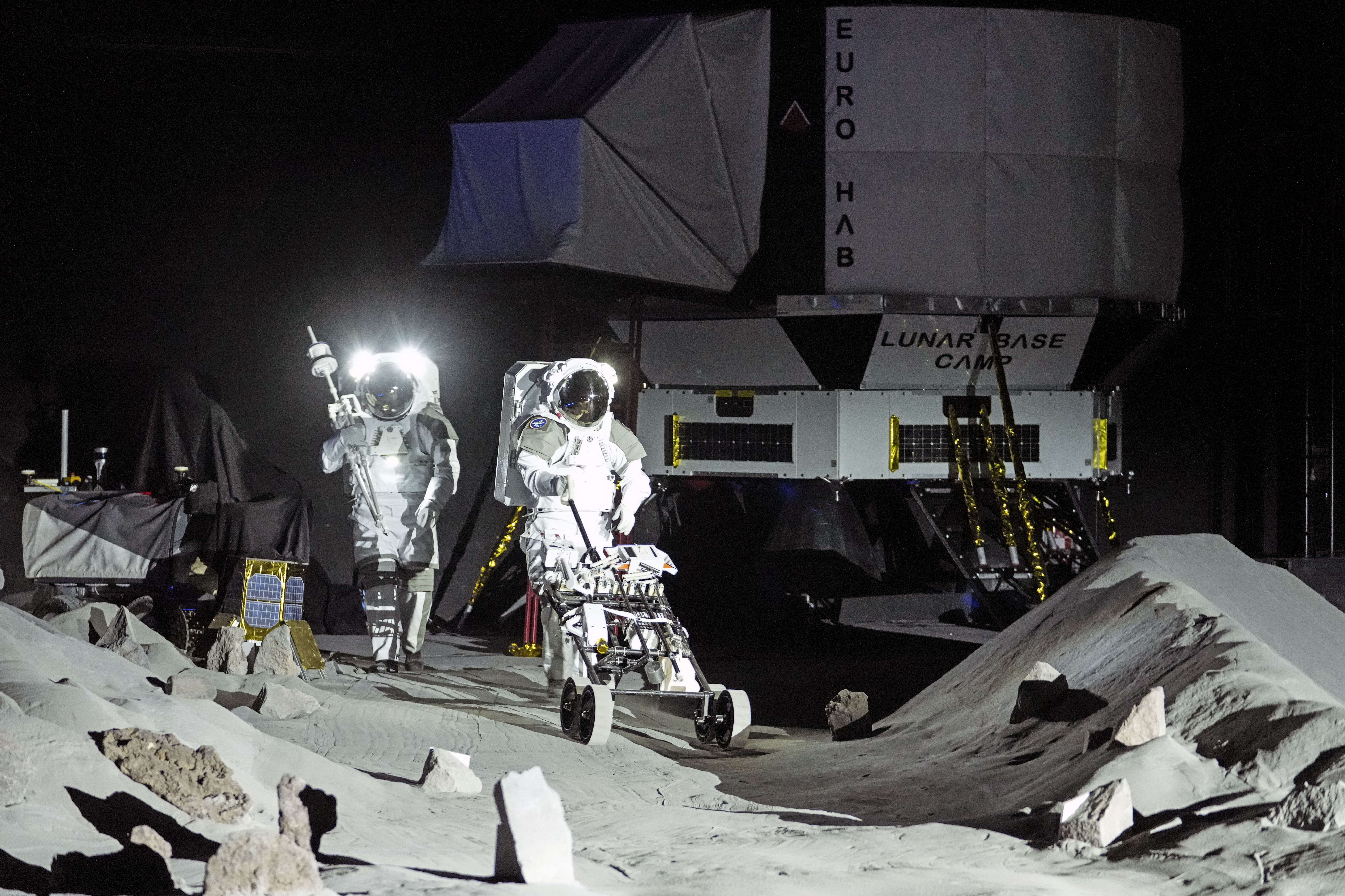 Astronauts Thomas Pesquet of France and Matthias Maurer of Germany demonstrate their training in lunar surface simulating conditions for future moon missions, like the Artemis lunar exploration program led by NASA, at the opening of the new LUNA facility at the European Astronaut Center in Cologne, Germany, Wednesday, Sept. 25, 2024. (AP Photo/Martin Meissner)