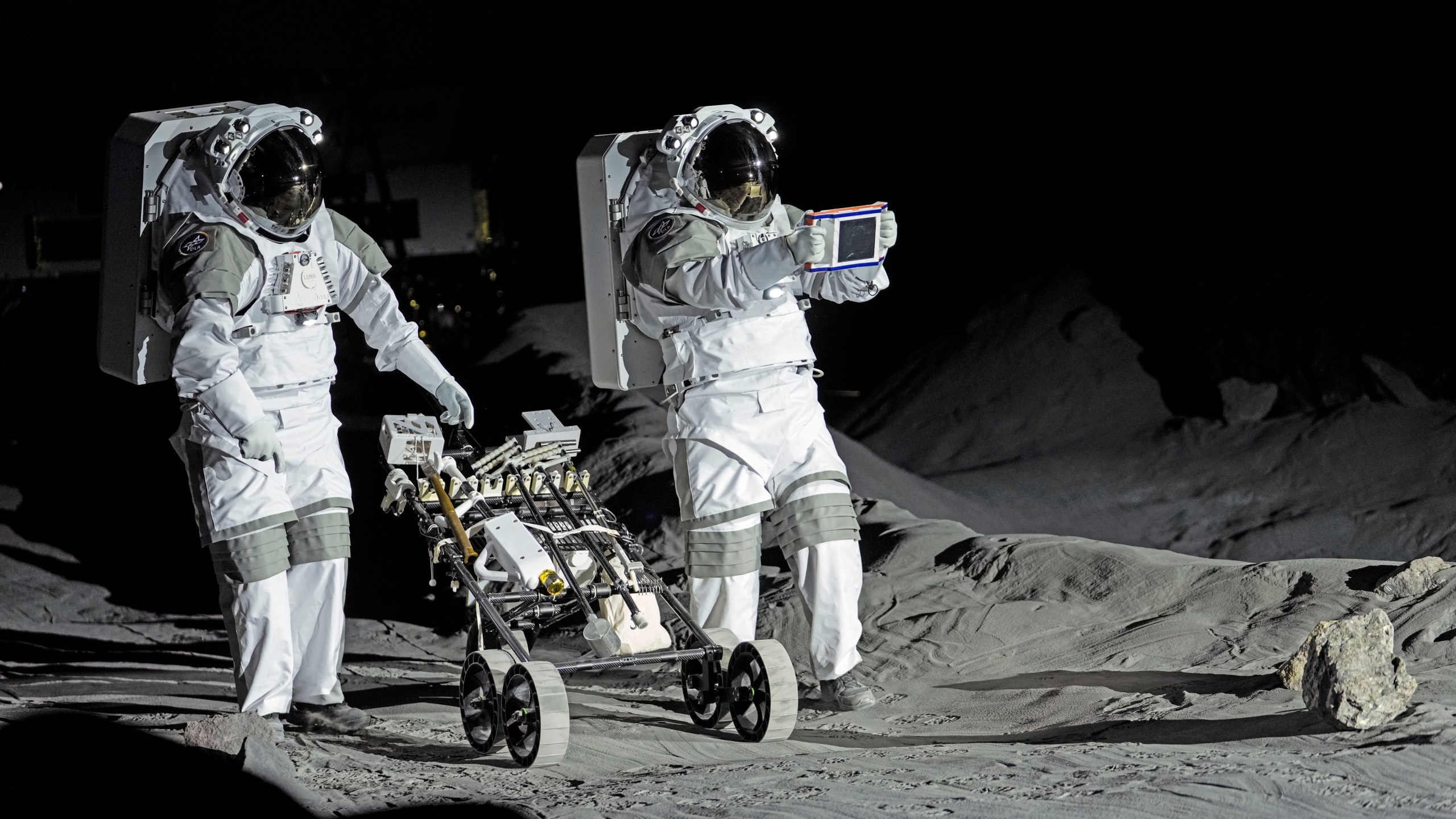 Astronauts Thomas Pesquet of France and Matthias Maurer of Germany demonstrate their training in lunar surface simulating conditions for future moon missions, like the Artemis lunar exploration program led by NASA, at the opening of the new LUNA facility at the European Astronaut Center in Cologne, Germany, Wednesday, Sept. 25, 2024. (AP Photo/Martin Meissner)