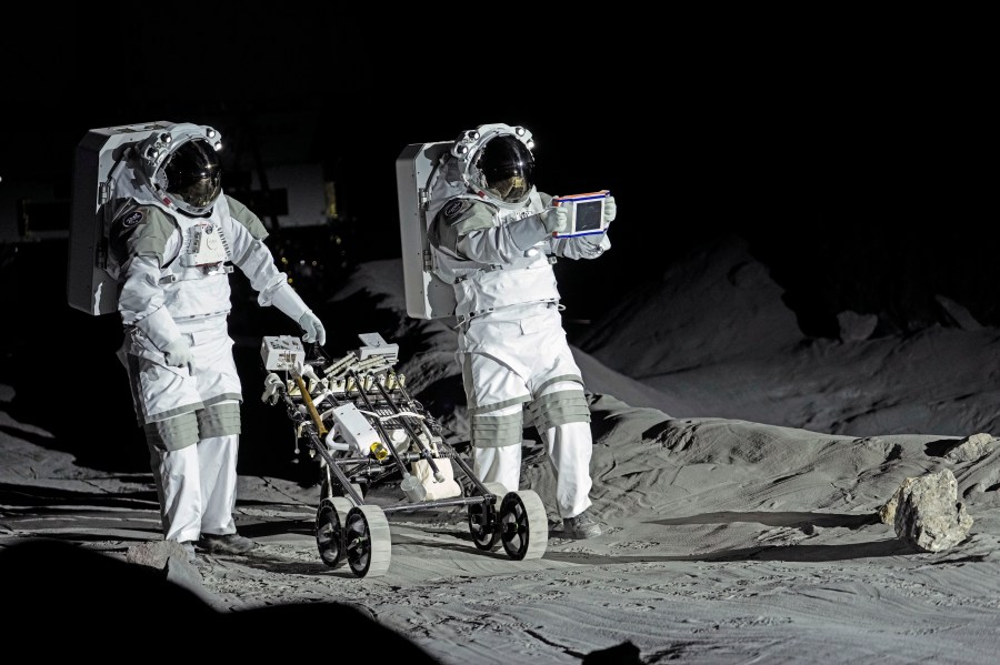 Astronauts Thomas Pesquet of France and Matthias Maurer of Germany demonstrate their training in lunar surface simulating conditions for future moon missions, like the Artemis lunar exploration program led by NASA, at the opening of the new LUNA facility at the European Astronaut Center in Cologne, Germany, Wednesday, Sept. 25, 2024. (AP Photo/Martin Meissner)