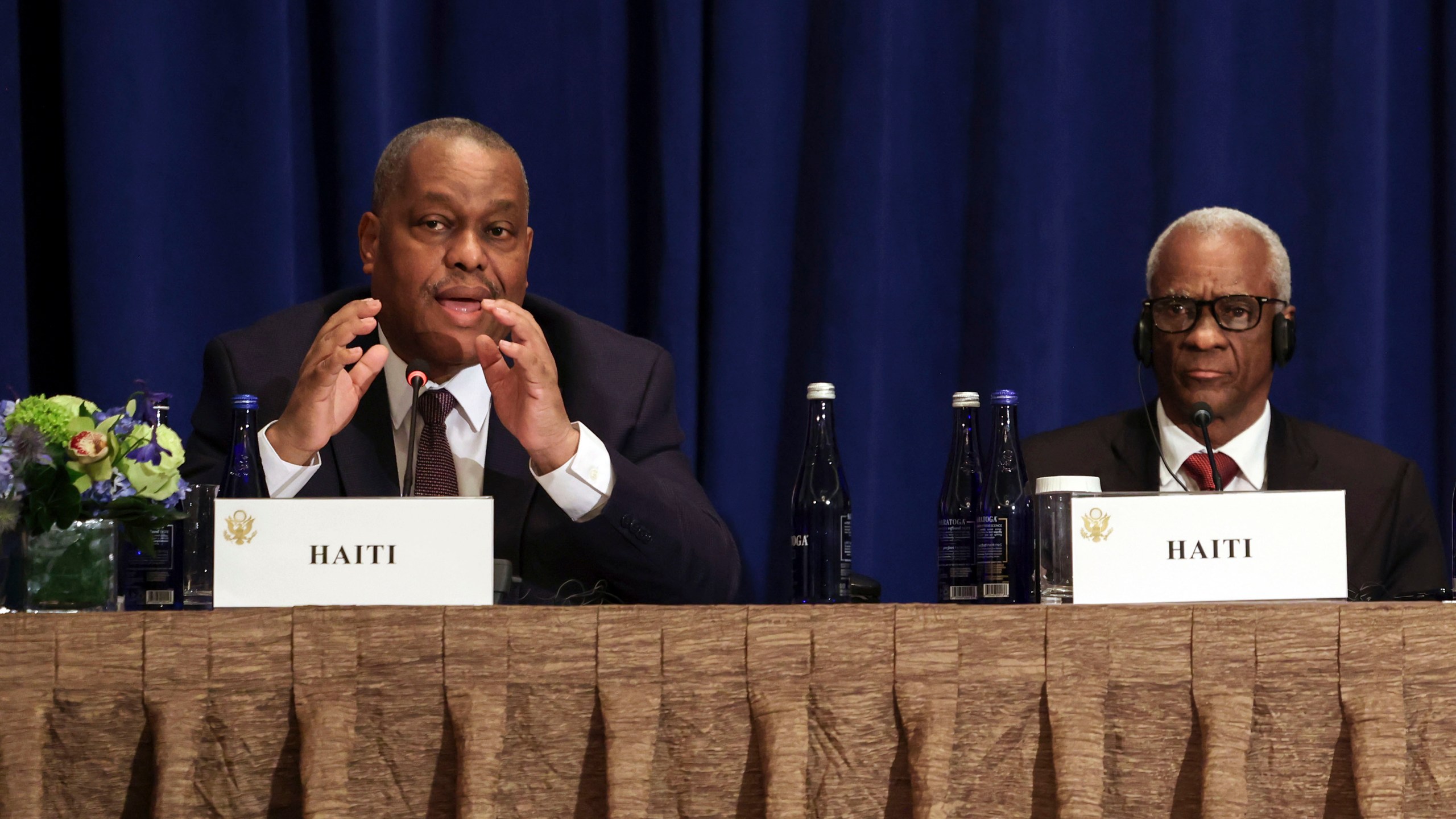 Haitian Prime Minister Garry Conille, left, speaks as President of the Haitian Transitional Presidential Council Edgard Leblanc Fils, right, and others listen during a Multilateral Meeting on Building on Progress to Restore Security in Haiti in New York, Wednesday, Sept. 25, 2024. (Caitlin Ochs/Pool Photo via AP)