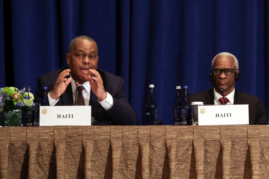 Haitian Prime Minister Garry Conille, left, speaks as President of the Haitian Transitional Presidential Council Edgard Leblanc Fils, right, and others listen during a Multilateral Meeting on Building on Progress to Restore Security in Haiti in New York, Wednesday, Sept. 25, 2024. (Caitlin Ochs/Pool Photo via AP)