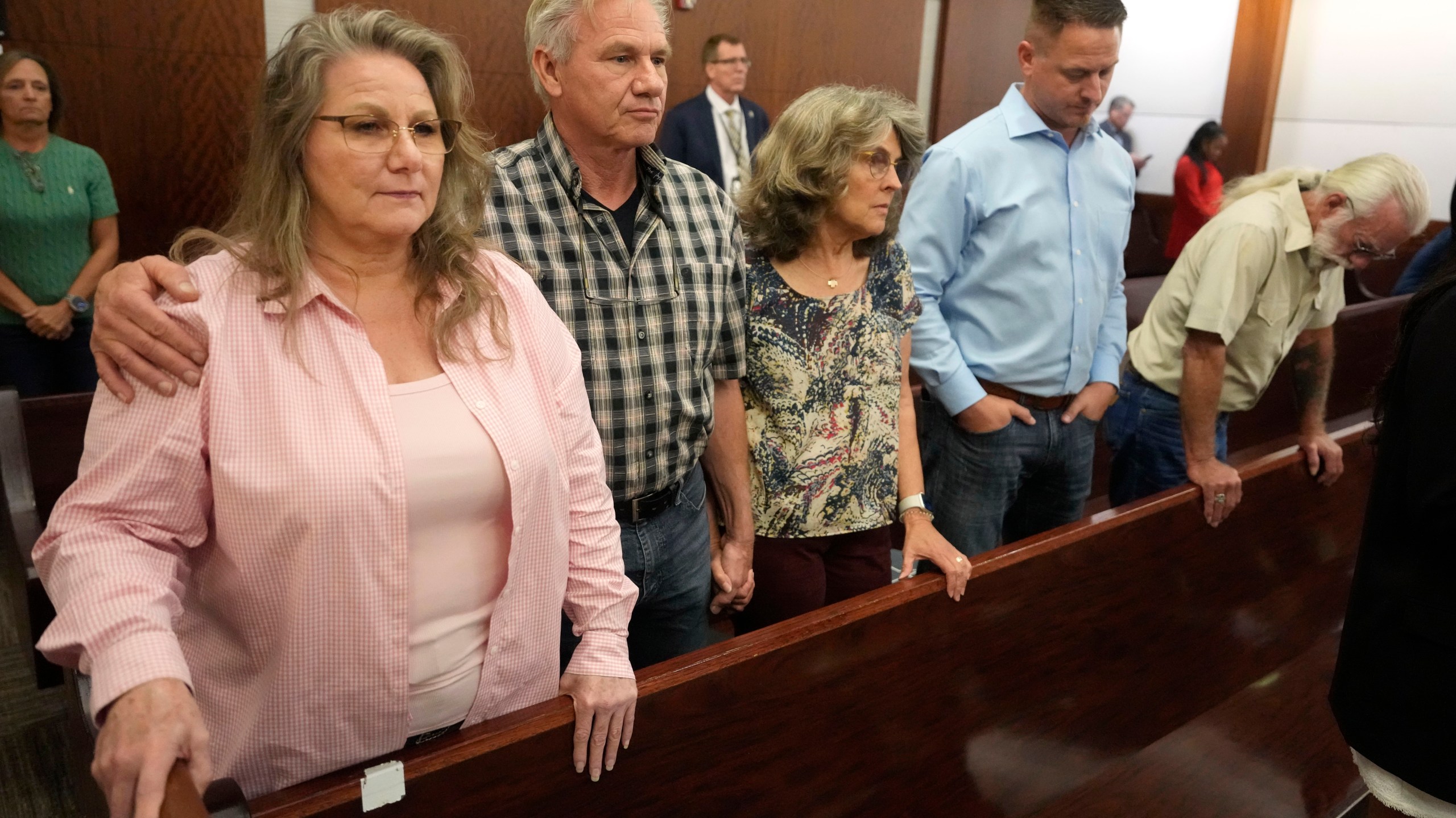 Family members of the late Dennis Tuttle wait for the jury to come into court for the verdict in murder trial of former Houston police officer Gerald Goines for the January 2019 deaths of Tuttle and Rhogena Nicholas, in the 482nd District Court at the Harris County Criminal courthouse Wednesday, Sept. 25, 2024, in Houston. Tuttle's siblings, from left, sister, Elizabeth Ferrari, and brother, Ron Tuttle, Ron's wife, Kristy Tuttle, Ryan Tuttle, son of Dennis Tuttle, and family friend Kenneth Ledbetter. (Melissa Phillip/Houston Chronicle via AP, Pool)