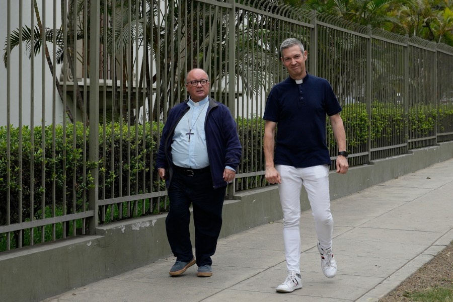 FILE - Vatican investigators Monsignor Jordi Bertomeu, right, from Spain, and Archbishop Charles Scicluna, from Malta, walk outside of the Nunciatura Apostolica during a break from meeting with people who alleged abuse by the Catholic lay group Sodalitium Christianae Vitae in Lima, Peru, on July 25, 2023. (AP Photo/Martin Mejia, File)