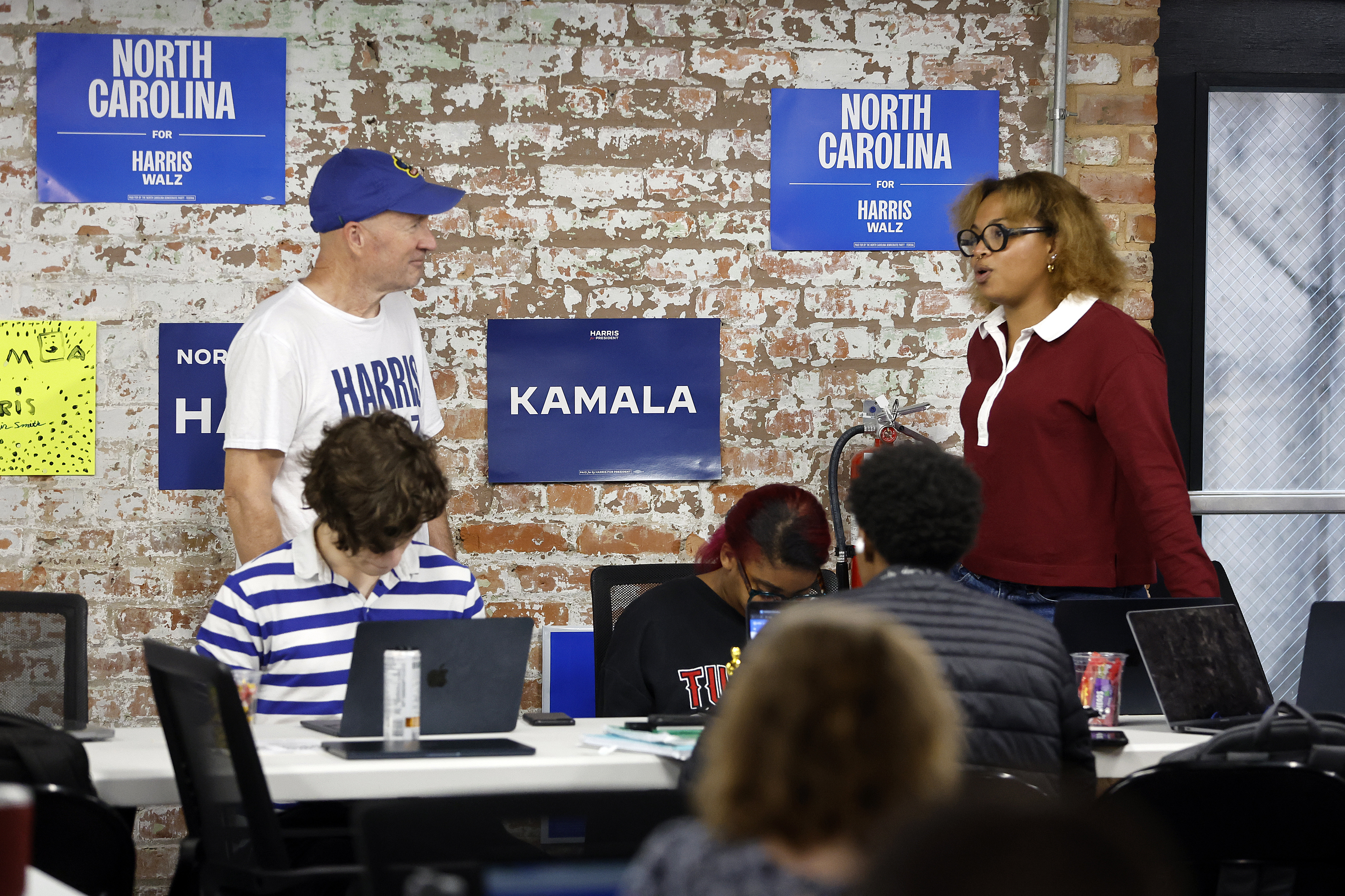 Volunteers and staff work at a democratic phone bank in Raleigh, N.C., Tuesday, Sept. 24, 2024. (AP Photo/Karl B DeBlaker)