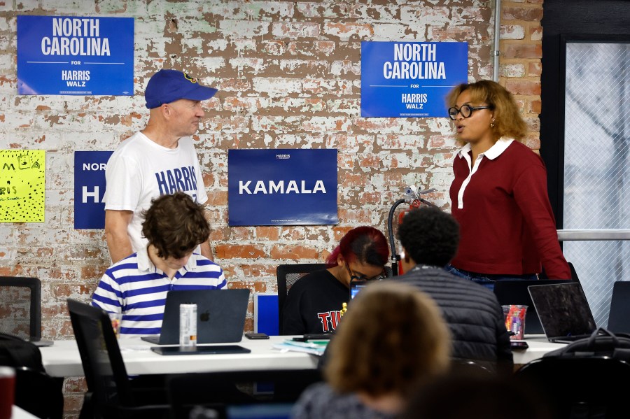 Volunteers and staff work at a democratic phone bank in Raleigh, N.C., Tuesday, Sept. 24, 2024. (AP Photo/Karl B DeBlaker)