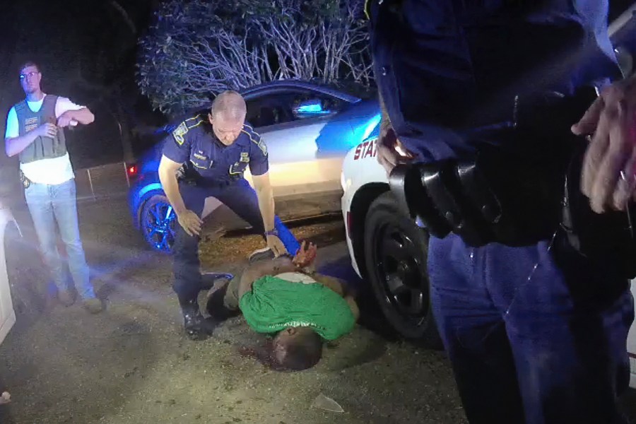 FILE — This image from video from Louisiana state trooper Lt. John Clary's body-worn camera shows trooper Kory York standing over Ronald Greene on his stomach on May 10, 2019, outside of Monroe, La. (Lt. John Clary/Louisiana State Police via AP, File)