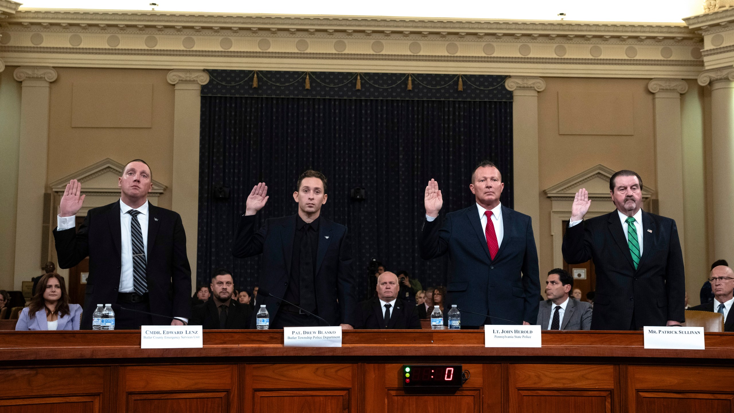 From left, Sgt. Edward Lenz, Commander of Butler County Emergency Services Unit, Patrolman Drew Blasko of Butler Township Police Dept., Lt. John Herold of Pennsylvania State Police, and former U.S. Secret Service agent Patrick Sullivan, swear in at the first public hearing of a bipartisan congressional task force investigating the assassination attempts against Republican presidential nominee former President Donald Trump, at Capitol Hill in Washington, Thursday, Sept. 26, 2024. (AP Photo/Ben Curtis)