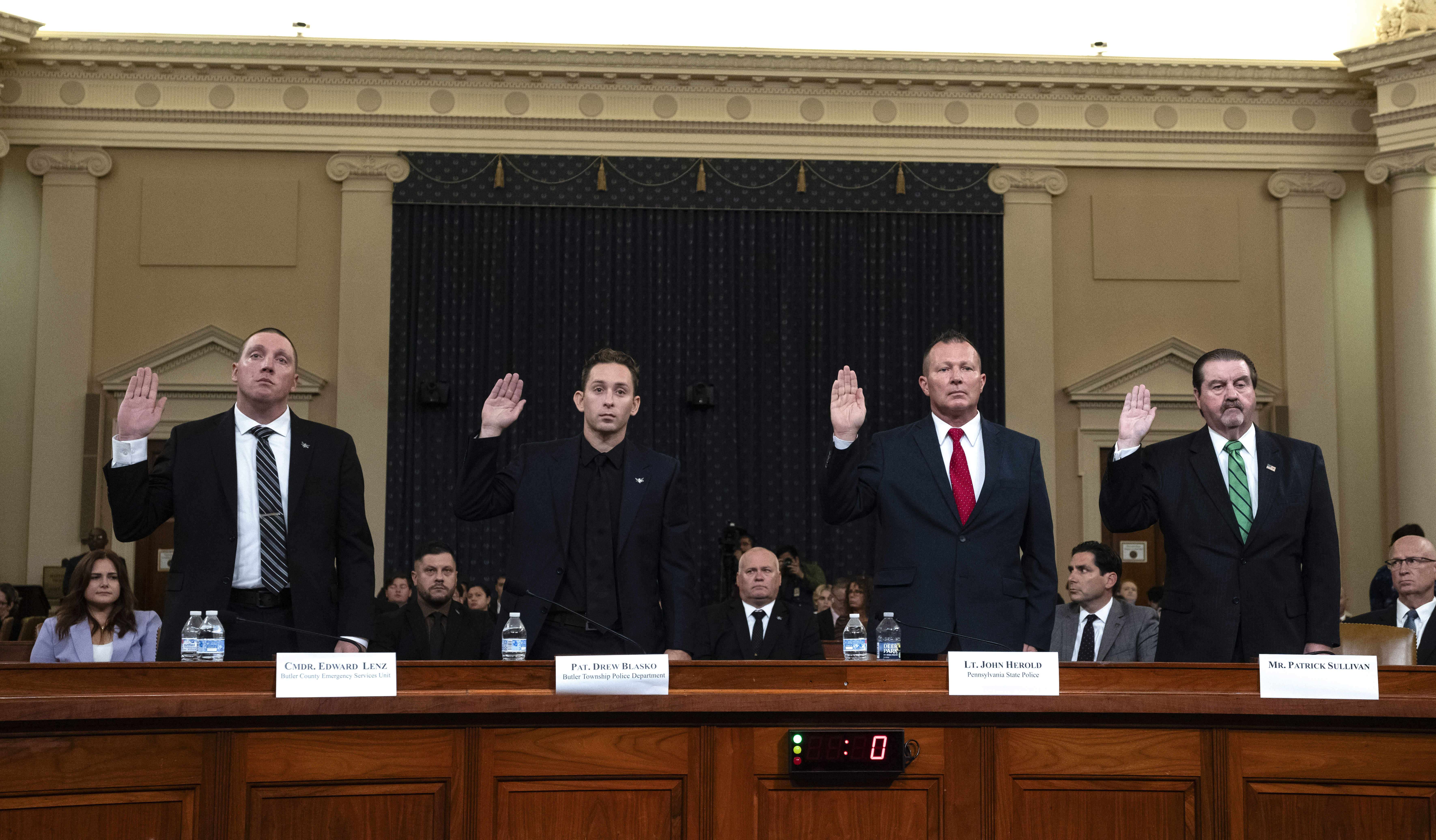 From left, Sgt. Edward Lenz, Commander of Butler County Emergency Services Unit, Patrolman Drew Blasko of Butler Township Police Dept., Lt. John Herold of Pennsylvania State Police, and former U.S. Secret Service agent Patrick Sullivan, swear in at the first public hearing of a bipartisan congressional task force investigating the assassination attempts against Republican presidential nominee former President Donald Trump, at Capitol Hill in Washington, Thursday, Sept. 26, 2024. (AP Photo/Ben Curtis)