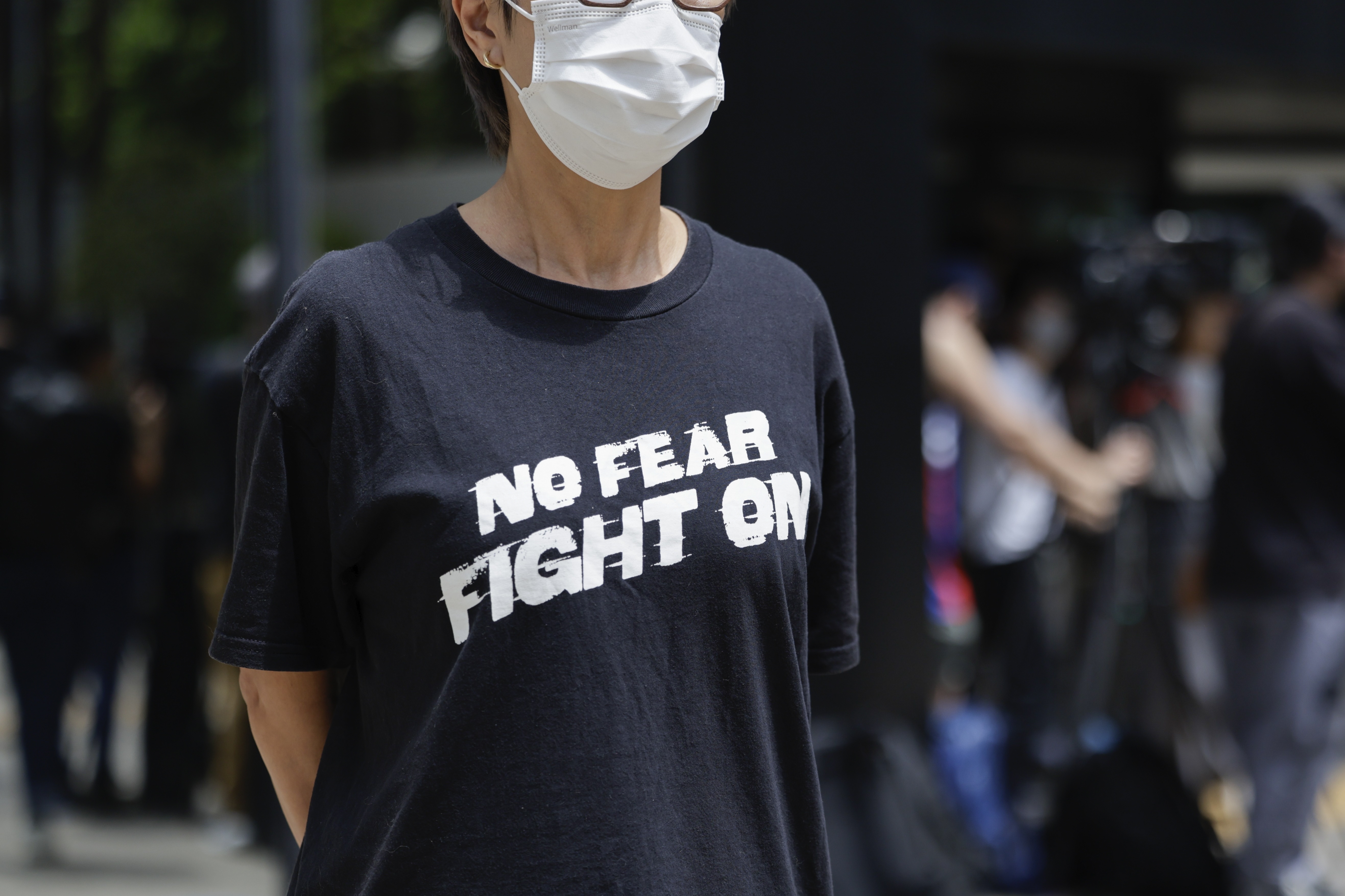 A member of the public stands outside the District Court in Wan Chai, Hong Kong, ahead of a sentencing hearing for two former Stand News editors convicted of sedition, Thursday, Sept. 26, 2024. (AP Photo/May James)