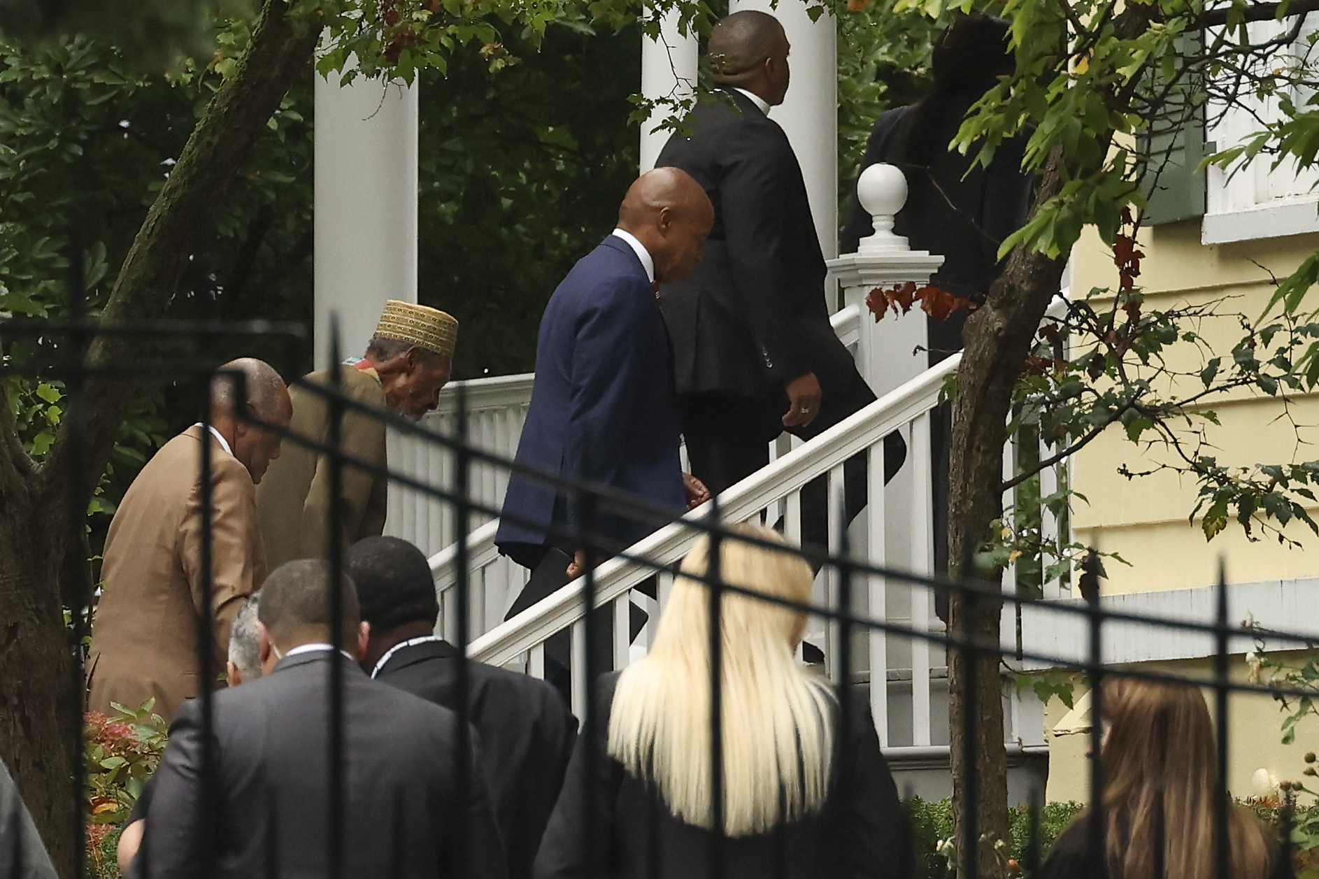 New York City Mayor Eric Adams, second from right, walks back into Gracie Mansion after speaking at a news conference outside Gracie Mansion, Thursday, Sept. 26, 2024, in New York. (AP Photo/Yuki Iwamura)