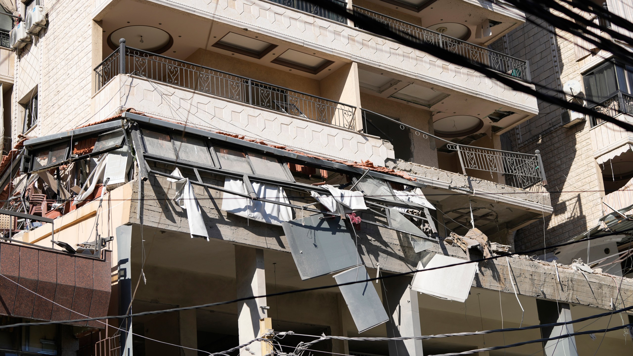 A damaged building at the site of an Israeli airstrike in Beirut's southern suburbs, Thursday, Sept. 26, 2024. (AP Photo/Hassan Ammar)