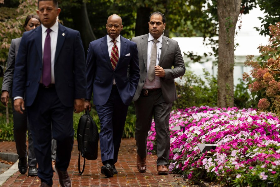 New York City Mayor Eric Adams, second right, exits Gracie Mansion, the official residence of the mayor, Thursday, Sept. 26, 2024, in New York. (AP Photo/Yuki Iwamura)