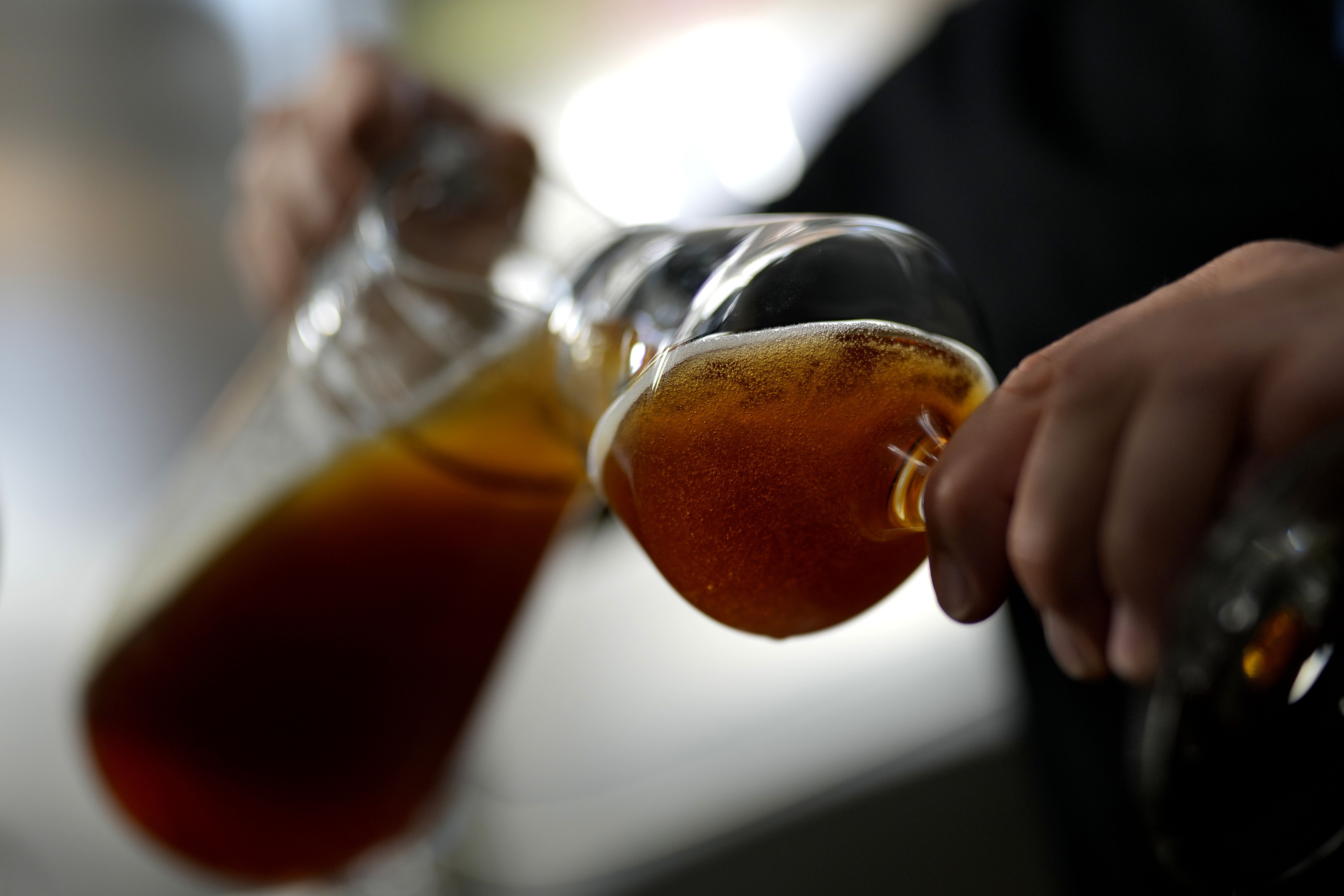 An employee of the Technical University of Munich fills beer in the brewery in Freising, Germany, Thursday, Sept. 19, 2024. (AP Photo/Matthias Schrader)