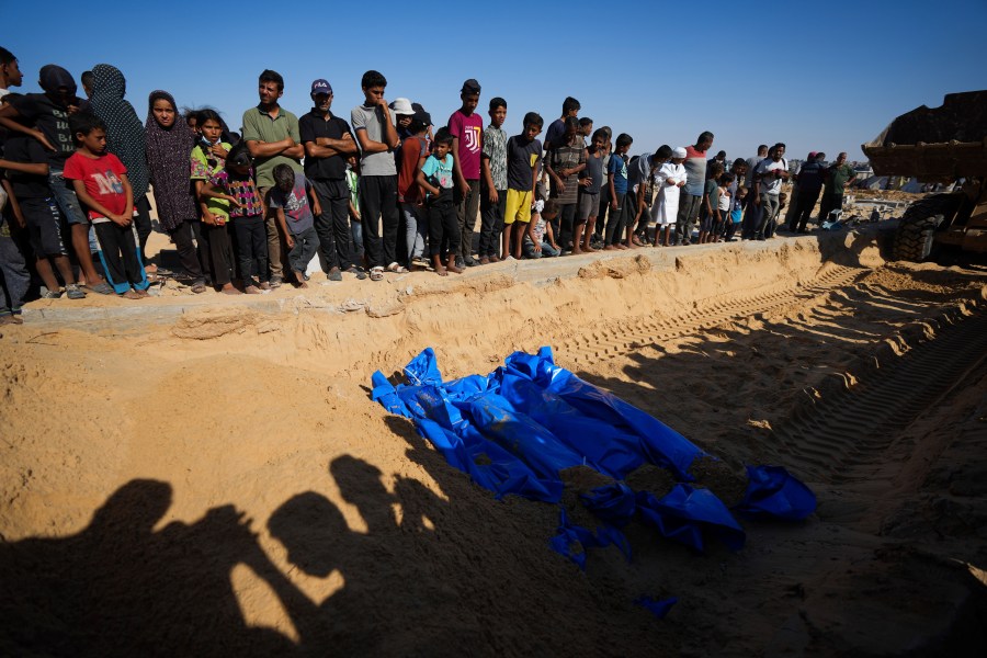 People bury the bodies of Palestinians taken by the Israeli military during operations in Gaza and returned this week, in Khan Younis, Gaza Strip, Thursday, Sept. 26, 2024. (AP Photo/Abdel Kareem Hana)