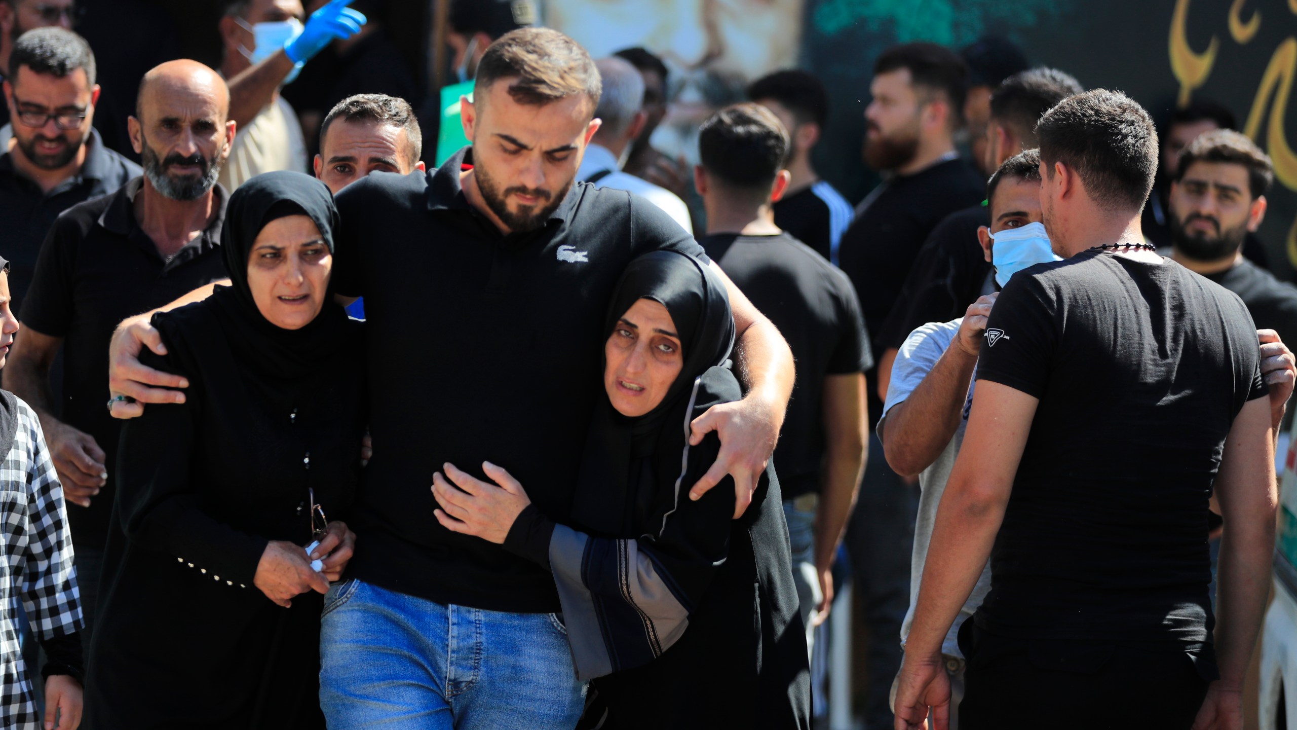 FILE - People react during the funeral procession of their relatives, who were killed in Monday's Israeli airstrikes, in the southern village of Saksakieh, Lebanon, Tuesday, Sept. 24, 2024. (AP Photo/Mohammed Zaatari, File)