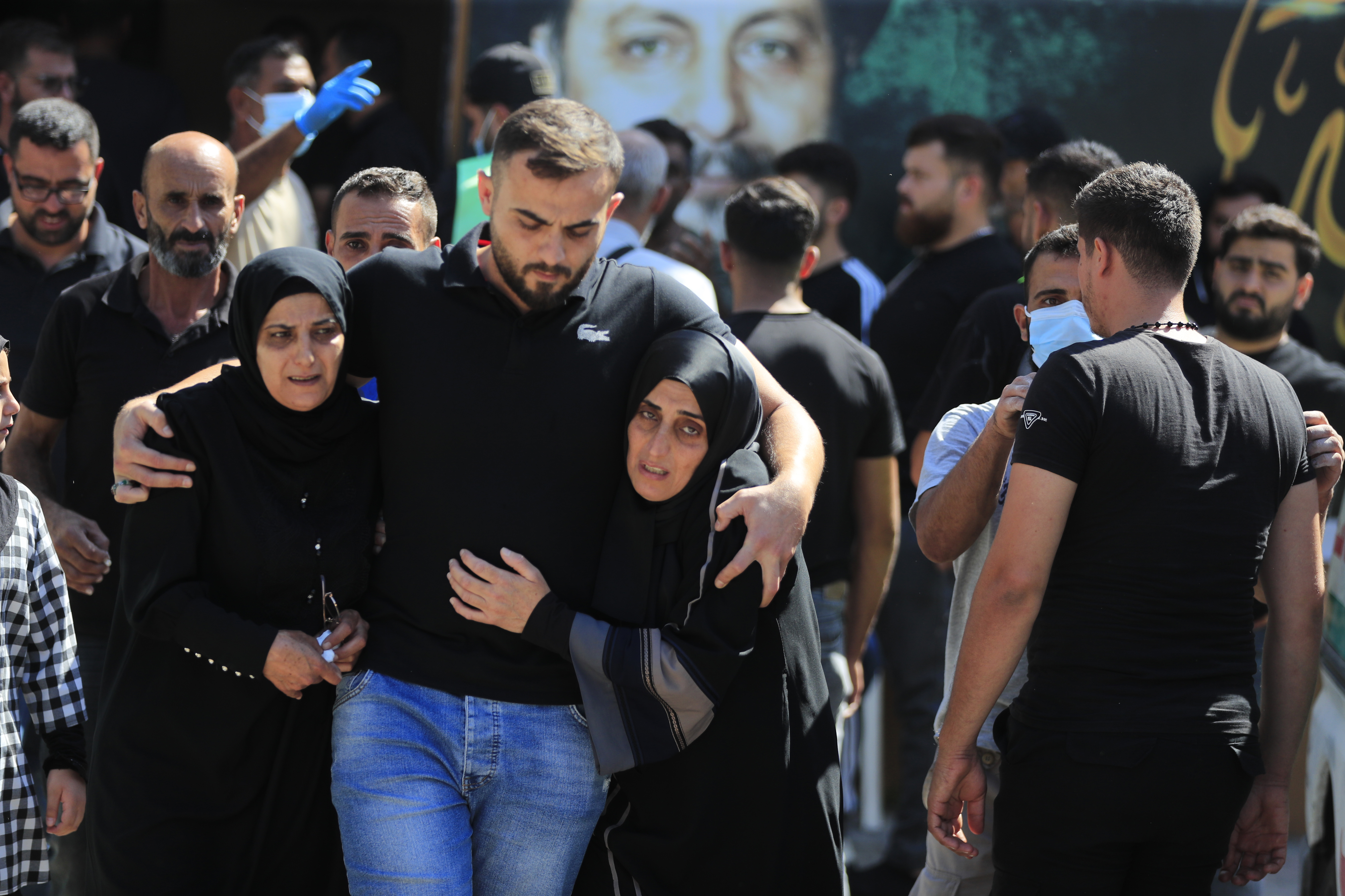 FILE - People react during the funeral procession of their relatives, who were killed in Monday's Israeli airstrikes, in the southern village of Saksakieh, Lebanon, Tuesday, Sept. 24, 2024. (AP Photo/Mohammed Zaatari, File)