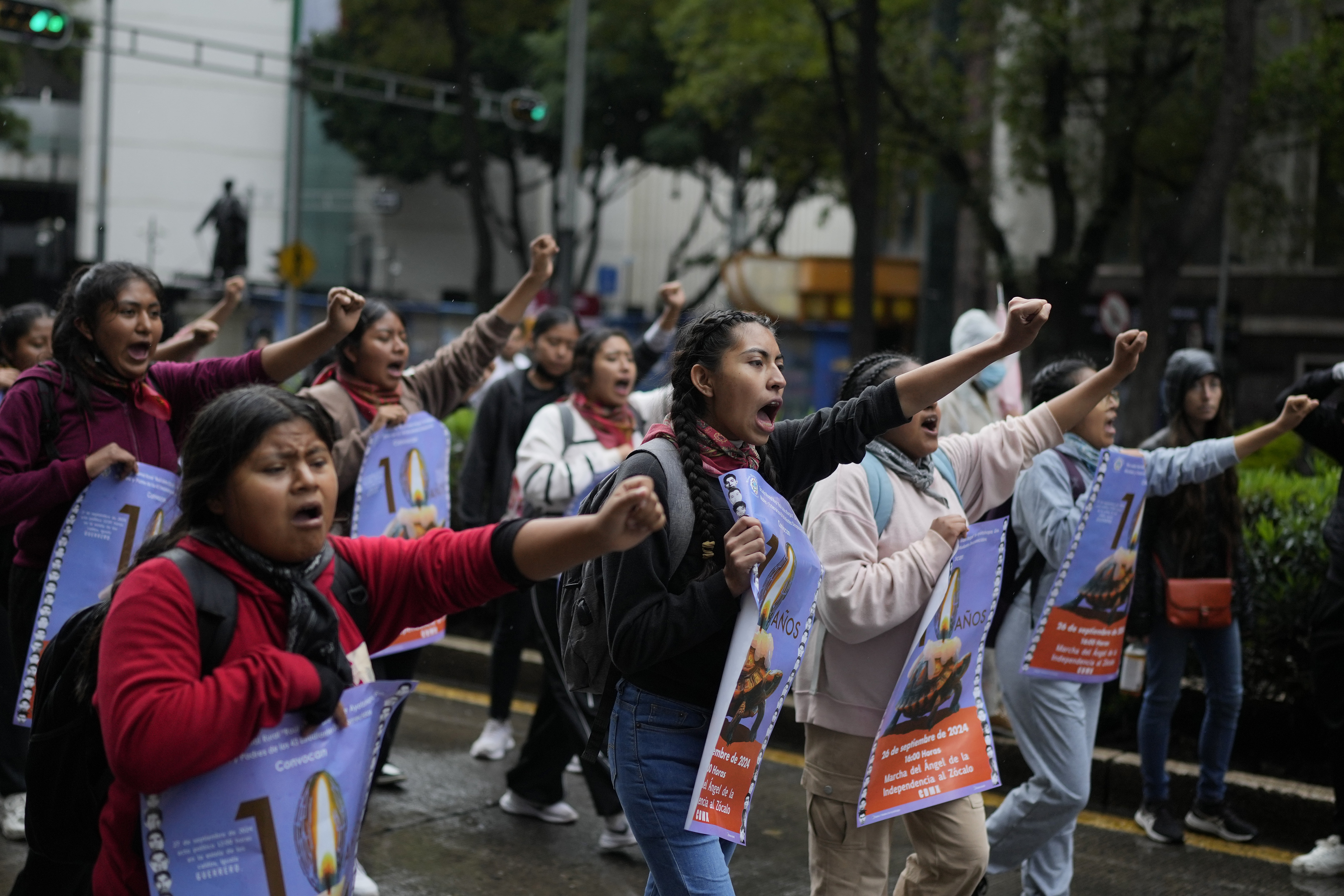 Youths take part in a demonstration marking the 10-year anniversary of the disappearance of 43 students from an Ayotzinapa rural teacher's college, in Mexico City, Thursday, Sept. 26, 2024. (AP Photo/Eduardo Verdugo)