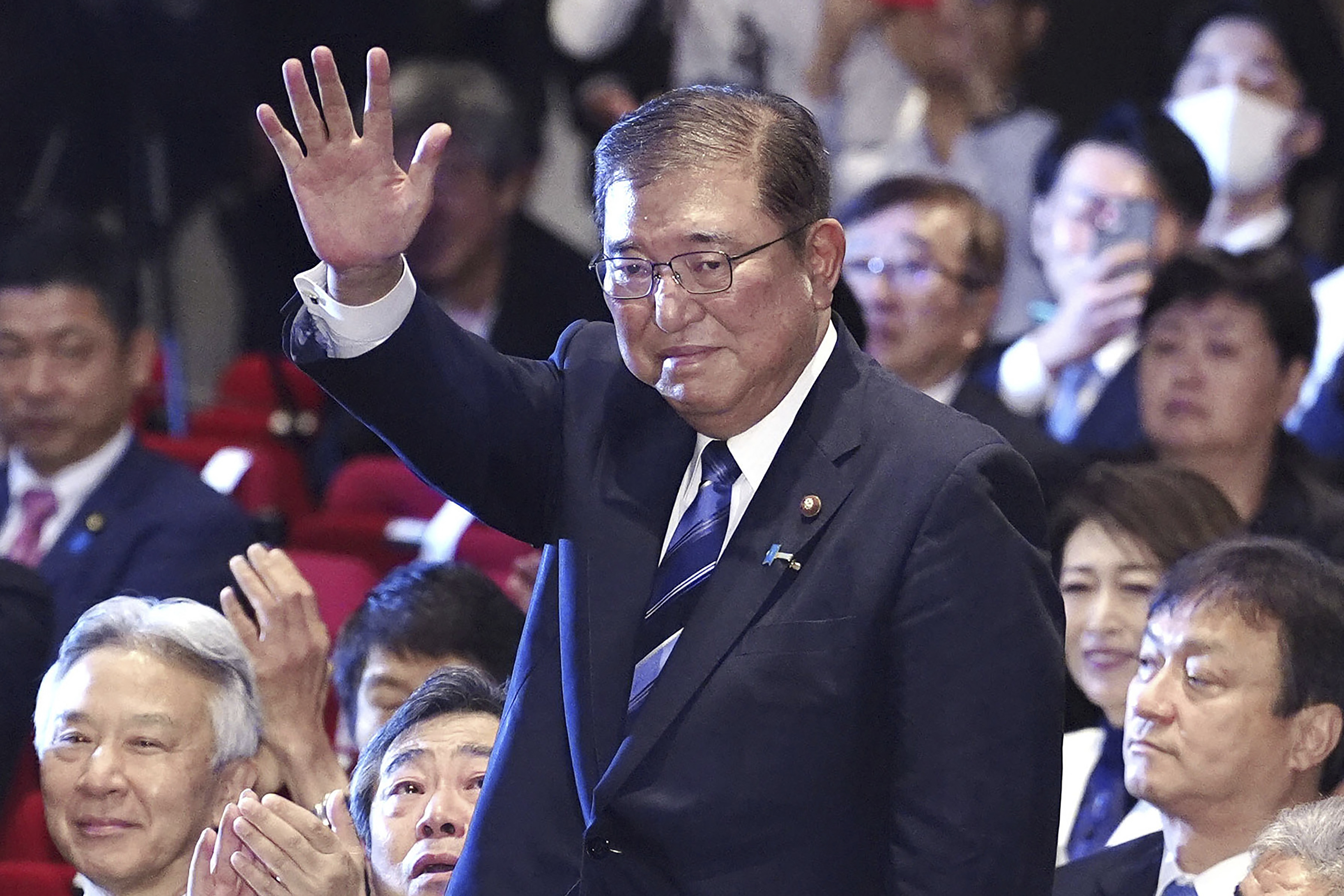 Shigeru Ishiba, center, waves as he is elected as leader of the ruling Liberal Democratic Party after the party's leadership election, in Tokyo Friday, Sept. 27, 2024. (Kyodo News via AP)