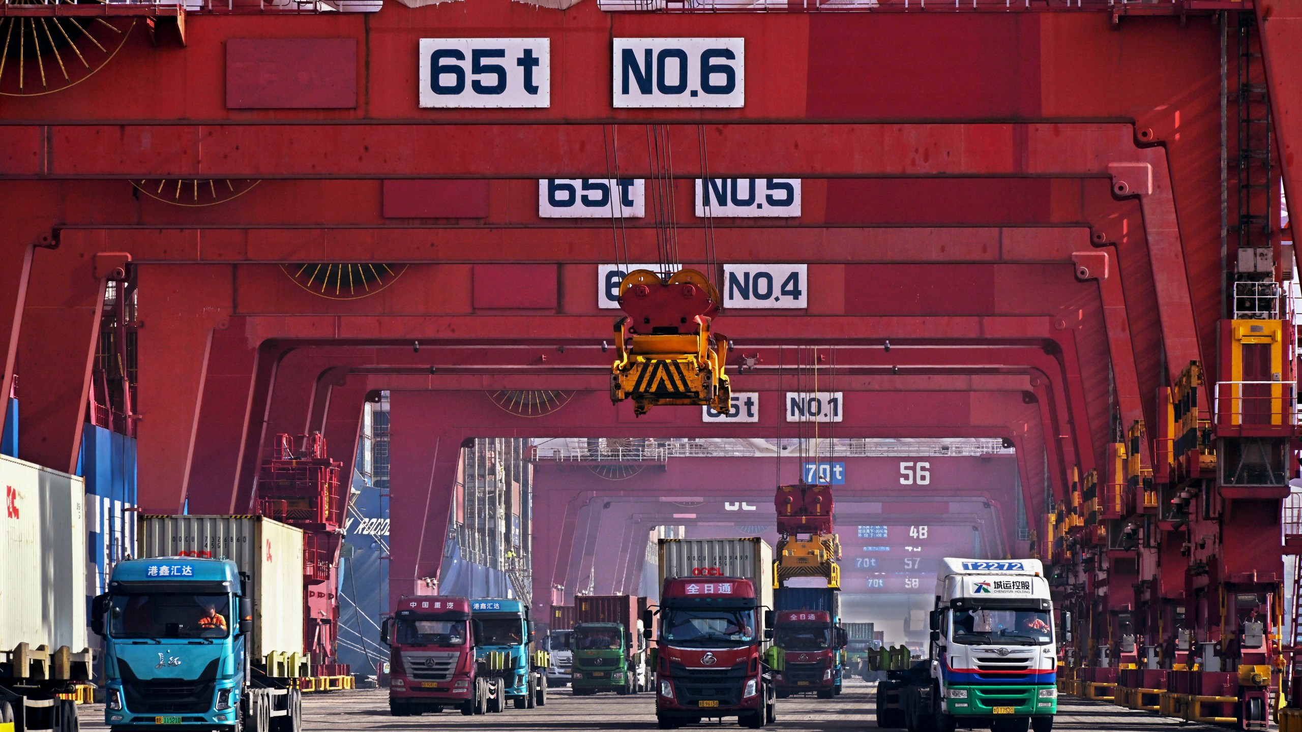 FILE - In this photo released by Xinhua News Agency, containers are unloaded from a cargo ship at Qingdao Port, east China's Shandong Province on Feb. 11, 2024. (Li Ziheng/Xinhua via AP, File)