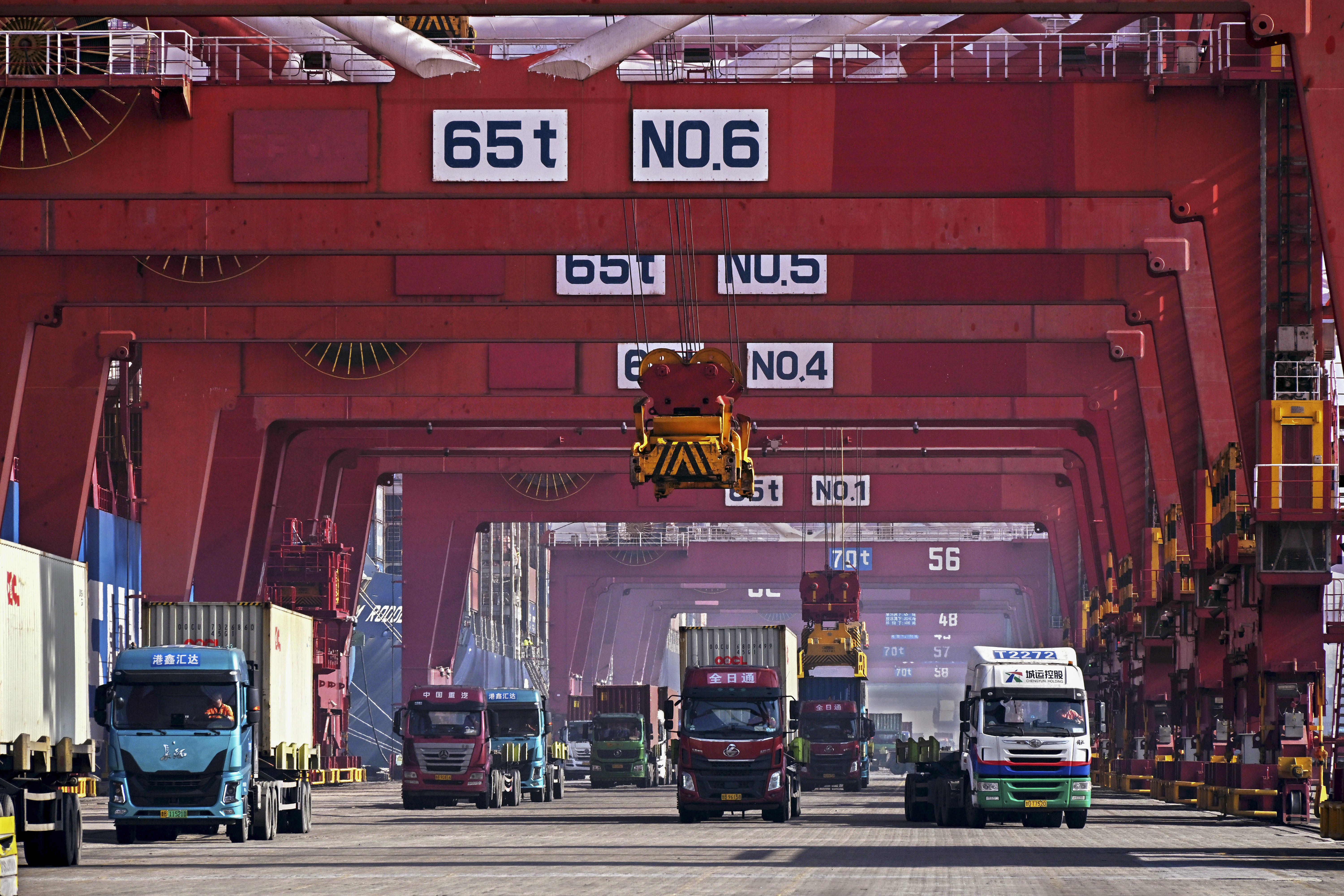 FILE - In this photo released by Xinhua News Agency, containers are unloaded from a cargo ship at Qingdao Port, east China's Shandong Province on Feb. 11, 2024. (Li Ziheng/Xinhua via AP, File)