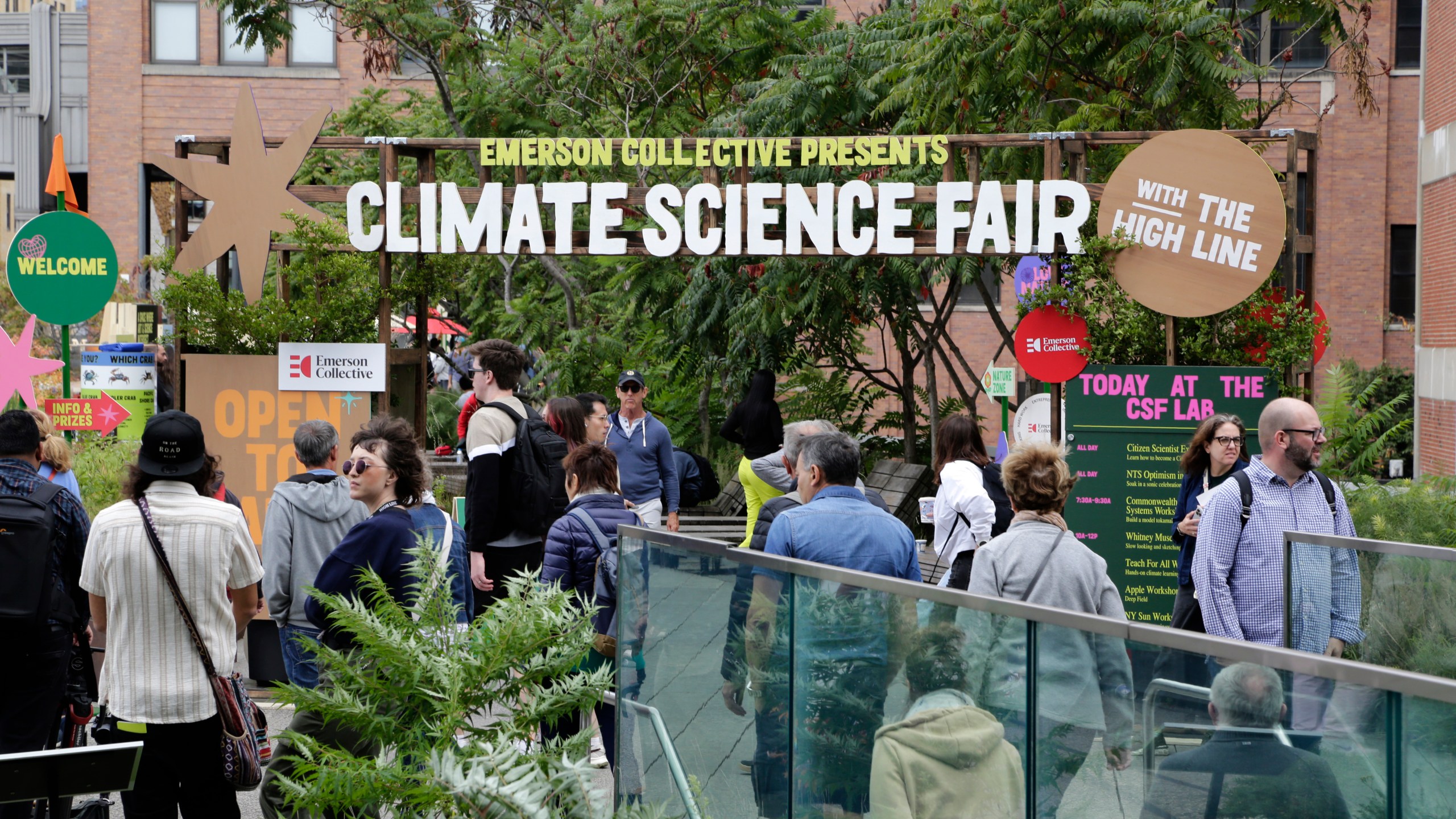 People arrive at the Climate Science Fair, an outdoor exhibit hosted by the Emerson Collective during the annual Climate Week NYC and United Nations General Assembly, on Monday, Sept. 23, 2024 in New York. (AP Photo/Peter Morgan)