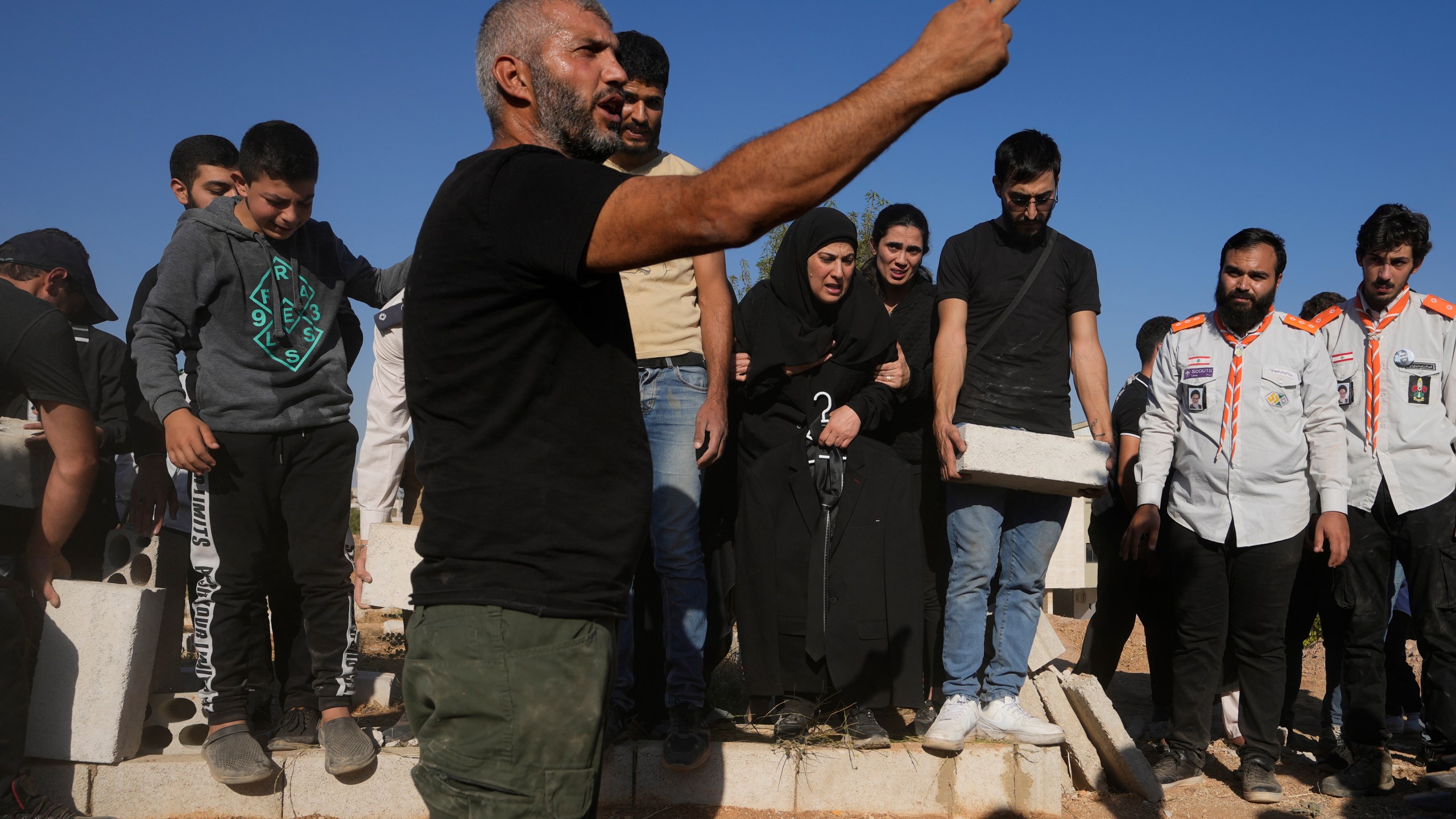 Mourners bury the bodies of their relatives, killed in Israeli airstrikes in the village of Karak, Bekaa Valley, eastern Lebanon, Friday, Sept. 27, 2024. (AP Photo/Hassan Ammar)