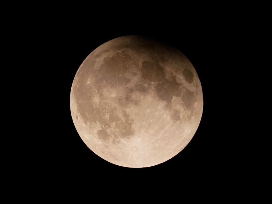 FILE - A supermoon with a partial lunar eclipse rises over Lake Michigan in Chicago, Tuesday, Sept. 17, 2024. (AP Photo/Kiichiro Sato, File)