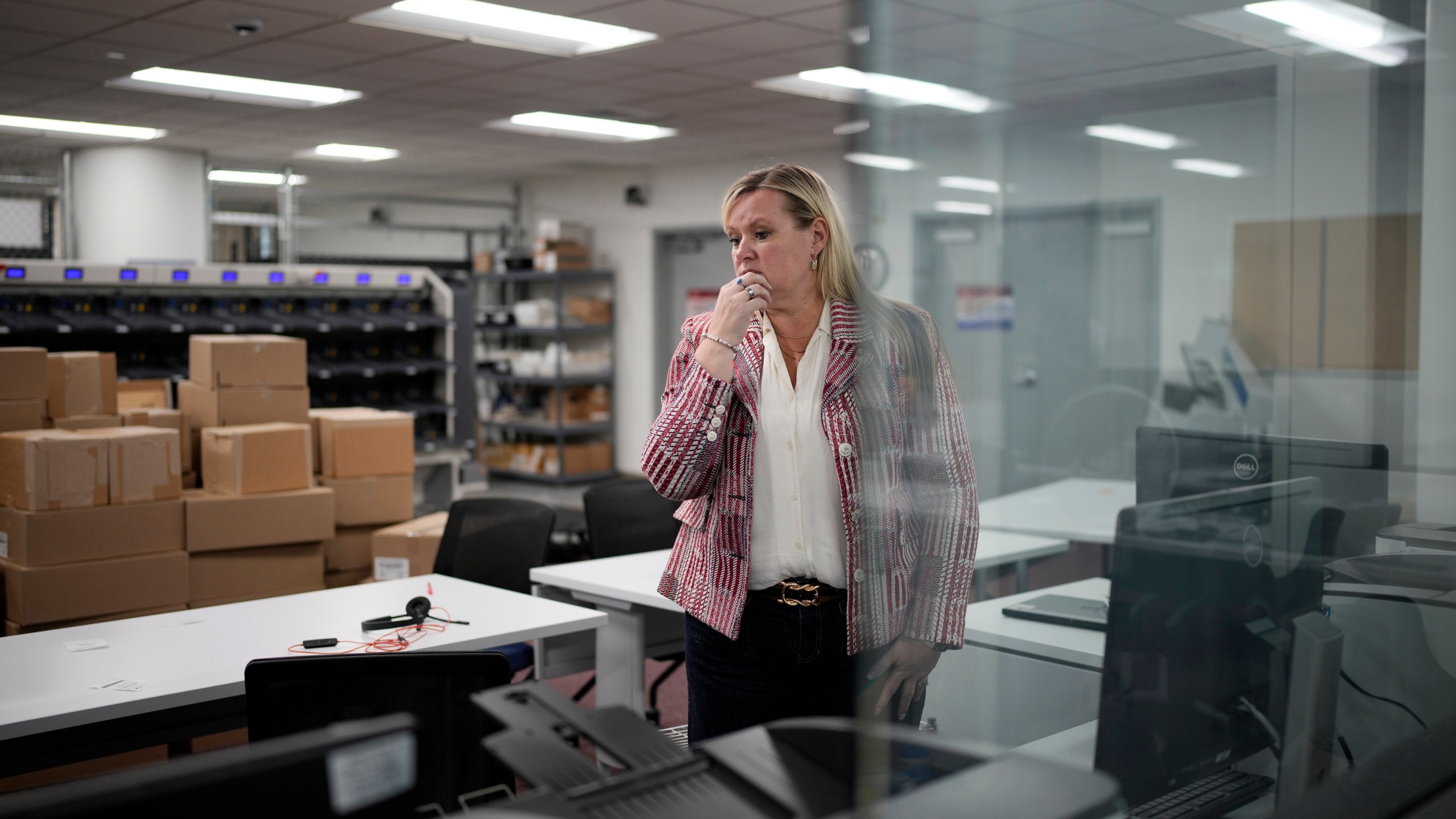 Cari-Ann Burgess, interim Registrar of Voters for Washoe County, Nev., pauses while helping prepare the office for elections, Sept. 20, 2024, in Reno, Nev. (AP Photo/John Locher)