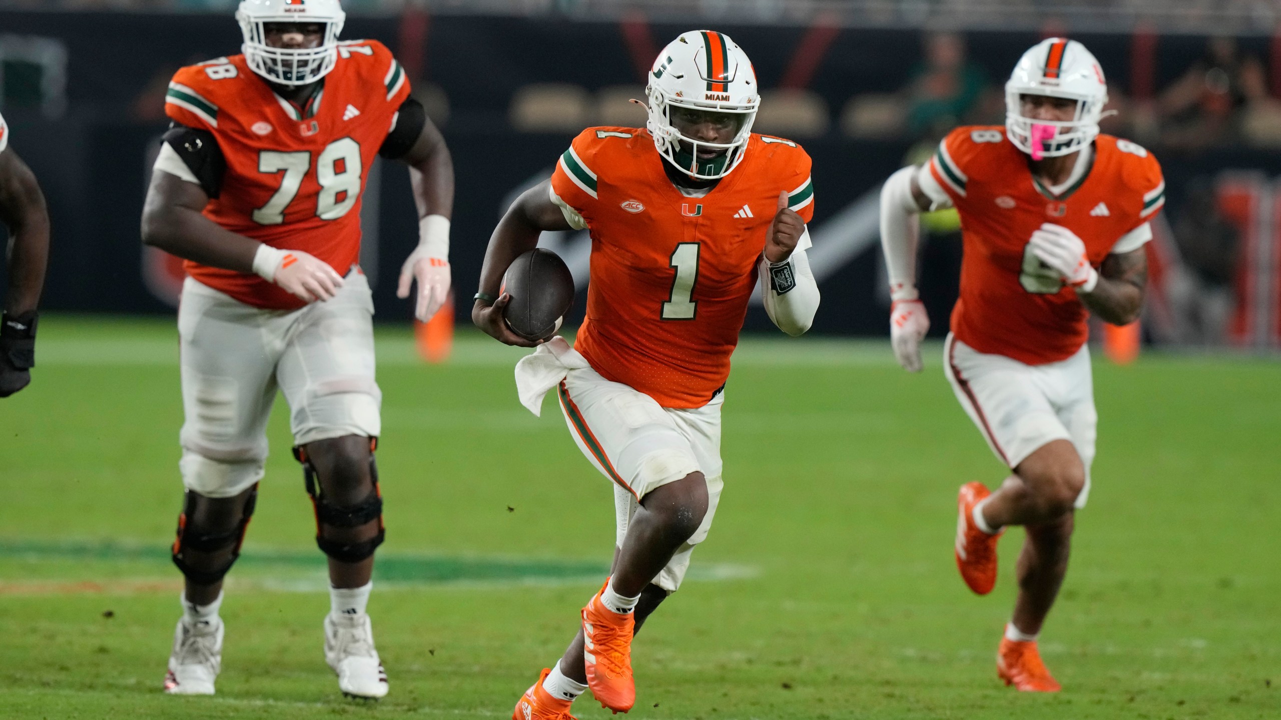 Miami quarterback Cam Ward (1) runs with the ball during the second half of an NCAA college football game against Virginia Tech , Friday, Sept. 27, 2024, in Miami Gardens, Fla. (AP Photo/Marta Lavandier)