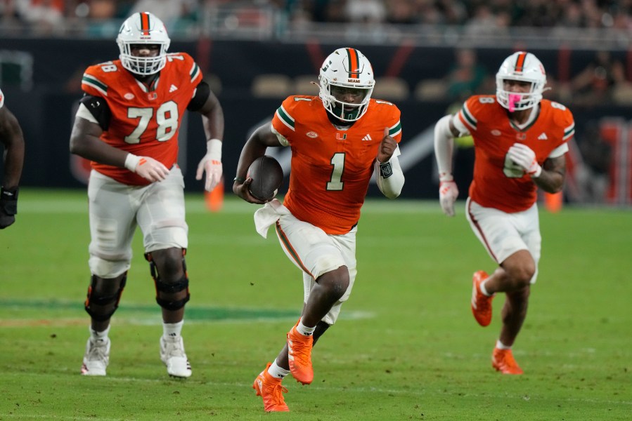 Miami quarterback Cam Ward (1) runs with the ball during the second half of an NCAA college football game against Virginia Tech , Friday, Sept. 27, 2024, in Miami Gardens, Fla. (AP Photo/Marta Lavandier)