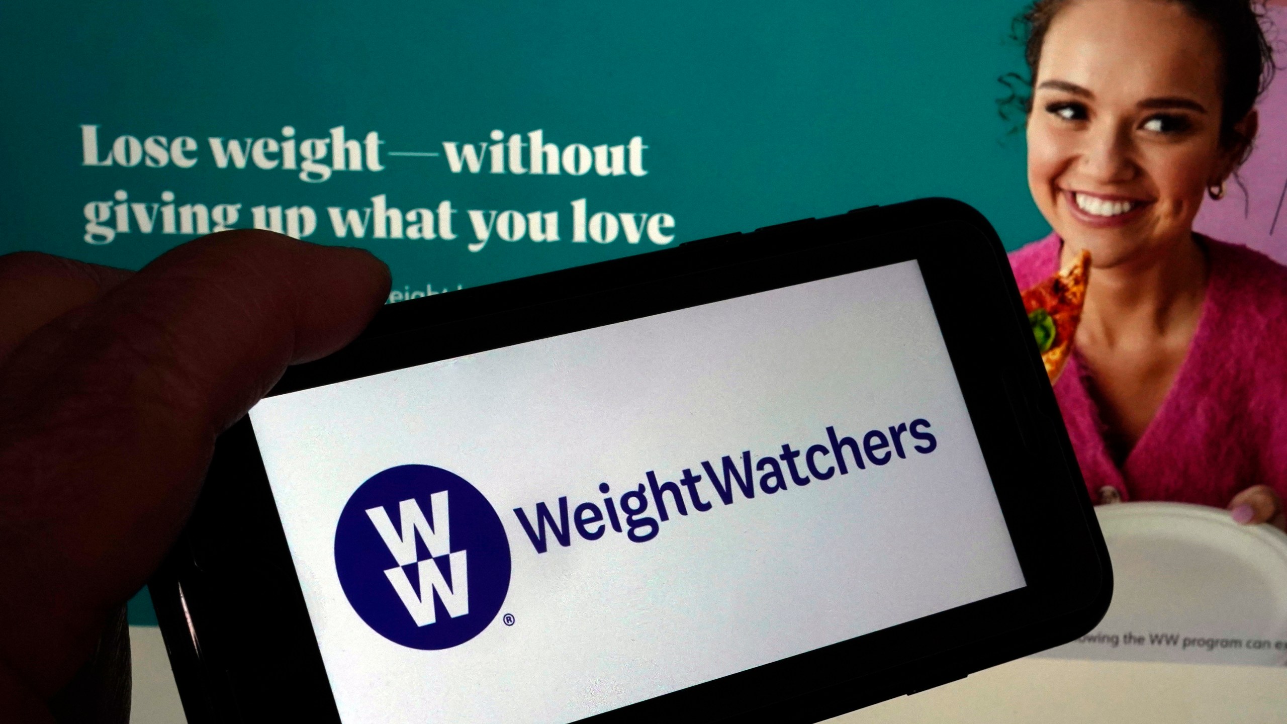 FILE - This image shows the logo of WeightWatchers on a mobile phone, and the company's website, in New York, Tuesday, March 7, 2023. (AP Photo/Richard Drew, File)