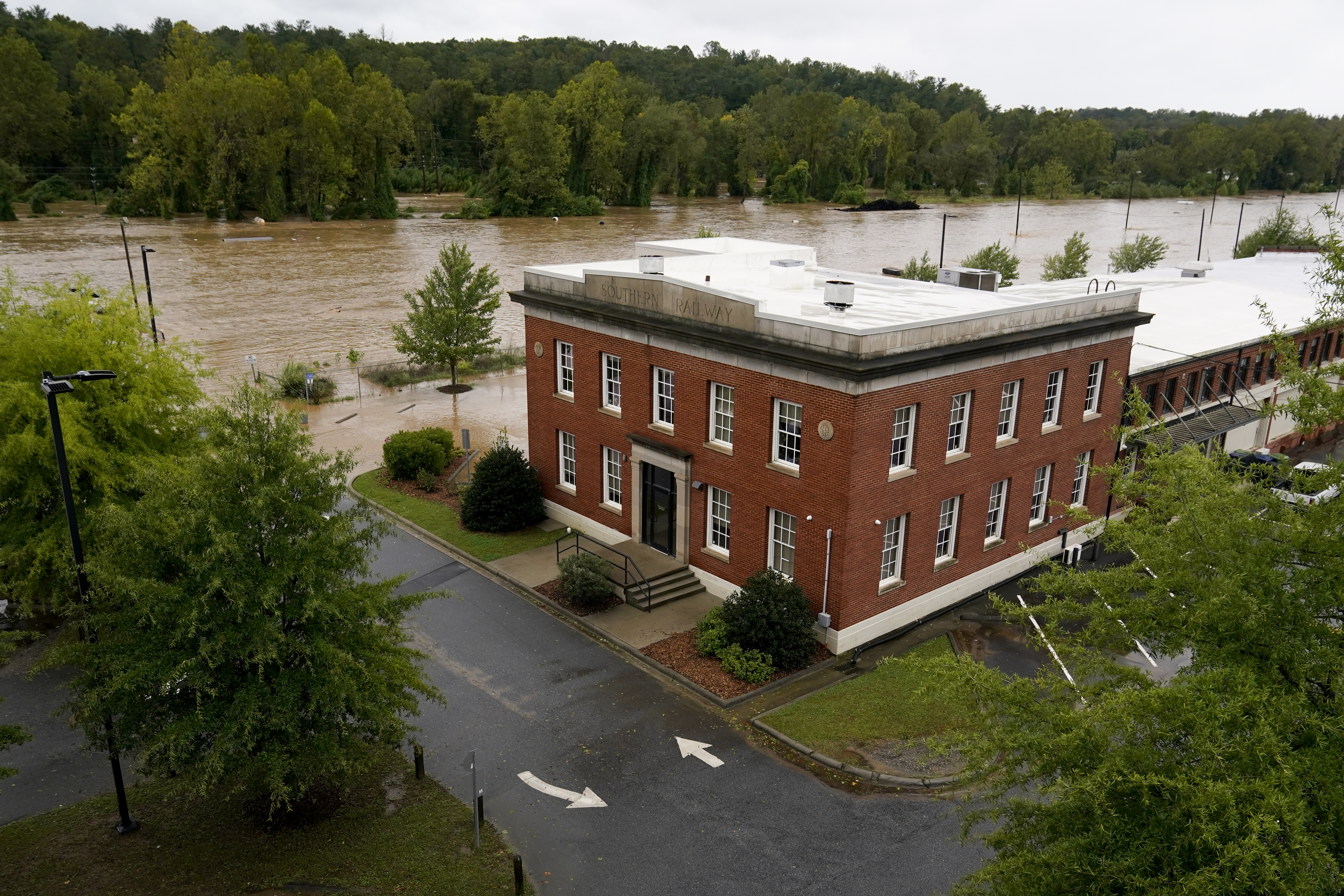 The banks of the Swannanoa river overflow an effect of Hurricane Helene, Friday, Sept. 27, 2024, in Asheville, N.C. (AP Photo/Erik Verduzco)