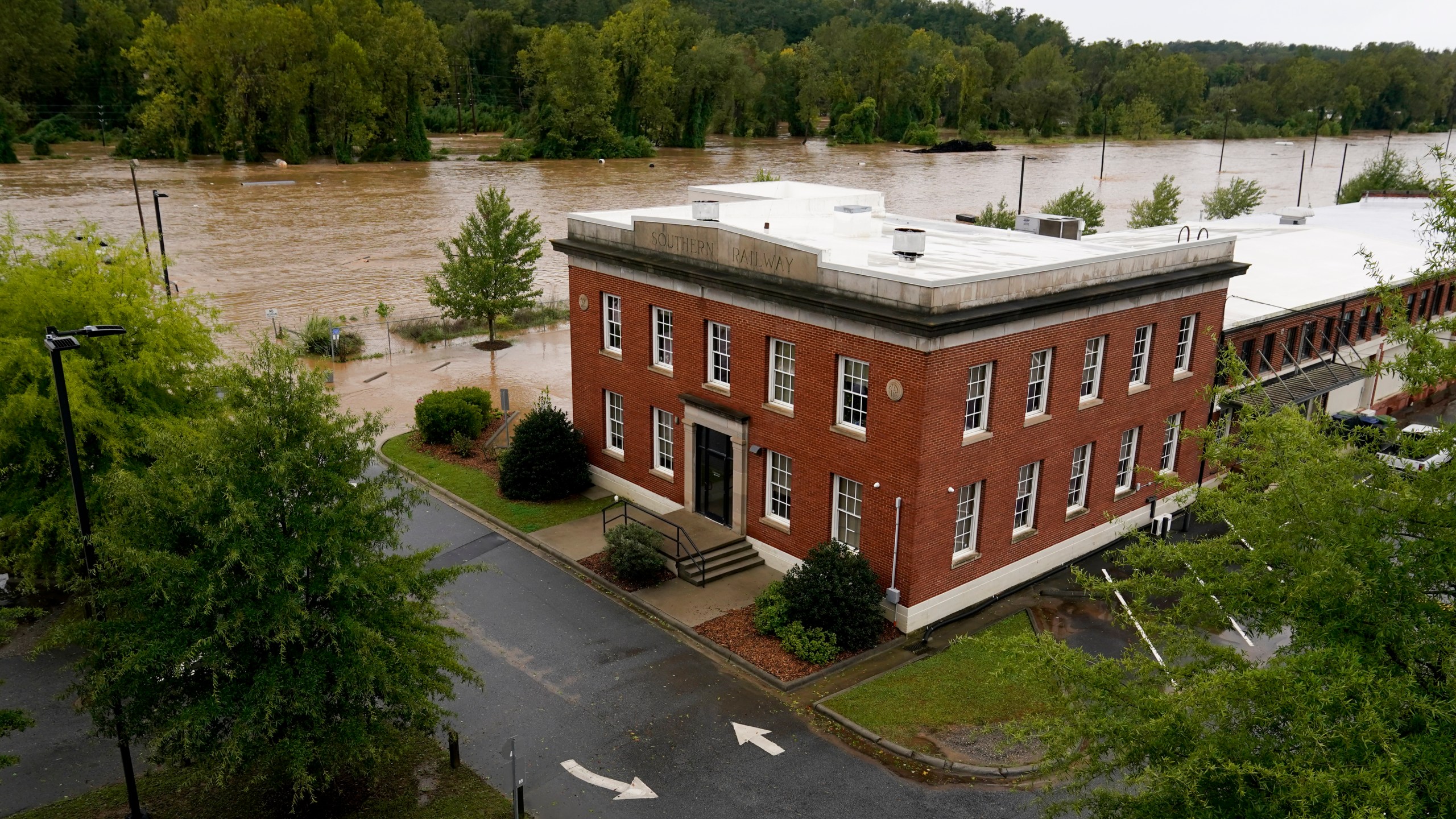 The banks of the Swannanoa river overflow an effect of Hurricane Helene, Friday, Sept. 27, 2024, in Asheville, N.C. (AP Photo/Erik Verduzco)