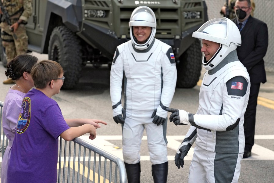 NASA astronaut Nick Hague, right, talks to his family members as Roscosmos cosmonaut Aleksandr Gorbunov looks on after leaving the Operations and Checkout building for a trip to the launch pad 40 Saturday, Sept. 28, 2024, at the Kennedy Space Center in Cape Canaveral, Fla. Two astronauts are beginning a mission to the International Space Station. (AP Photo/Chris O'Meara)