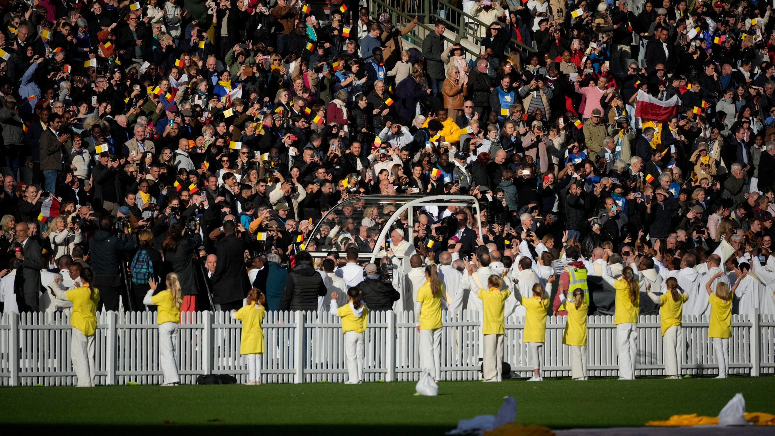 Pope Francis is cheered by faithful as he arrives to preside over the Sunday mass in King Baudouin Stadium, in Brussels Sunday, Sept. 29, 2024. (AP Photo/Andrew Medichini)